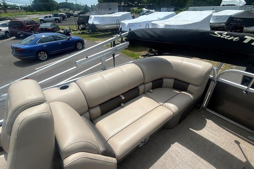 2023 Sun Tracker Party Barge 22 DLX with beige seating, parked in a lot.