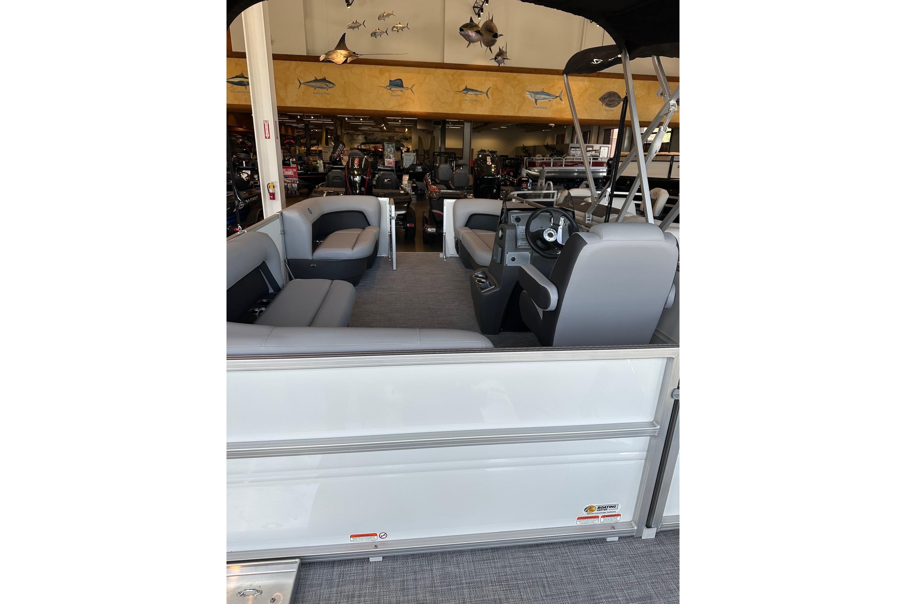 2026 Sun Tracker Party Barge 16 DLX interior with seating and steering console.