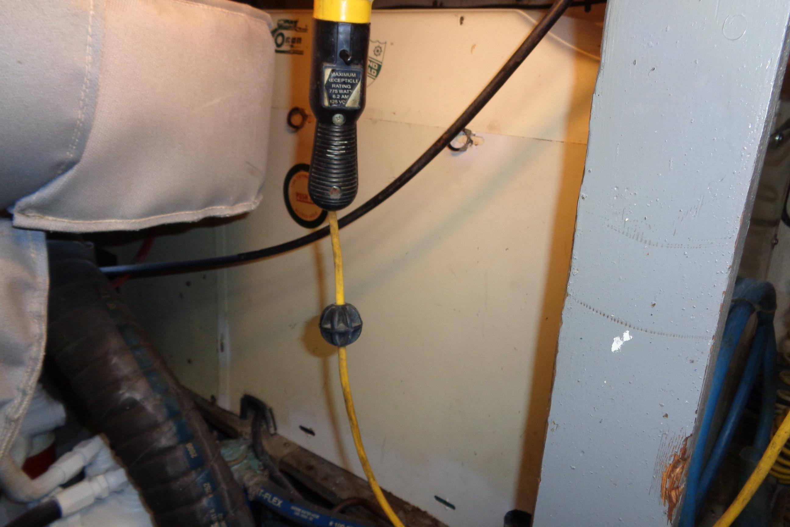 Engine room of 1981 Hatteras 48 Cockpit Motor Yacht with visible wiring and components.