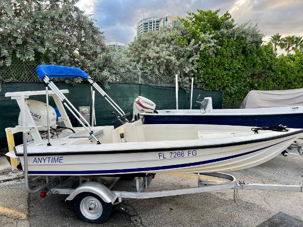 1986 Hoog Comet 14 boat on trailer with blue canopy, labeled ANYTIME.