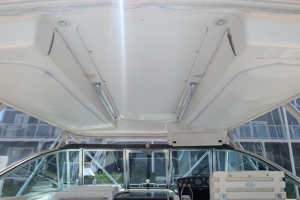 Interior view of a 2000 Pursuit 3400 Express boat, showcasing the helm and overhead design.
