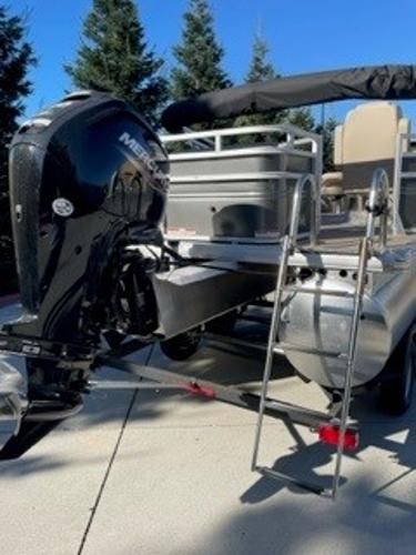 2024 Sun Tracker Fishin' Barge 20 DLX pontoon boat with Mercury outboard motor.