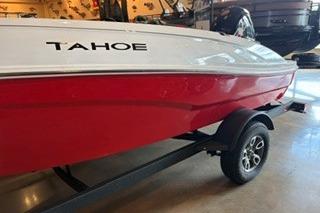 2026 Tahoe T18 boat with red and white design on a trailer in showroom.
