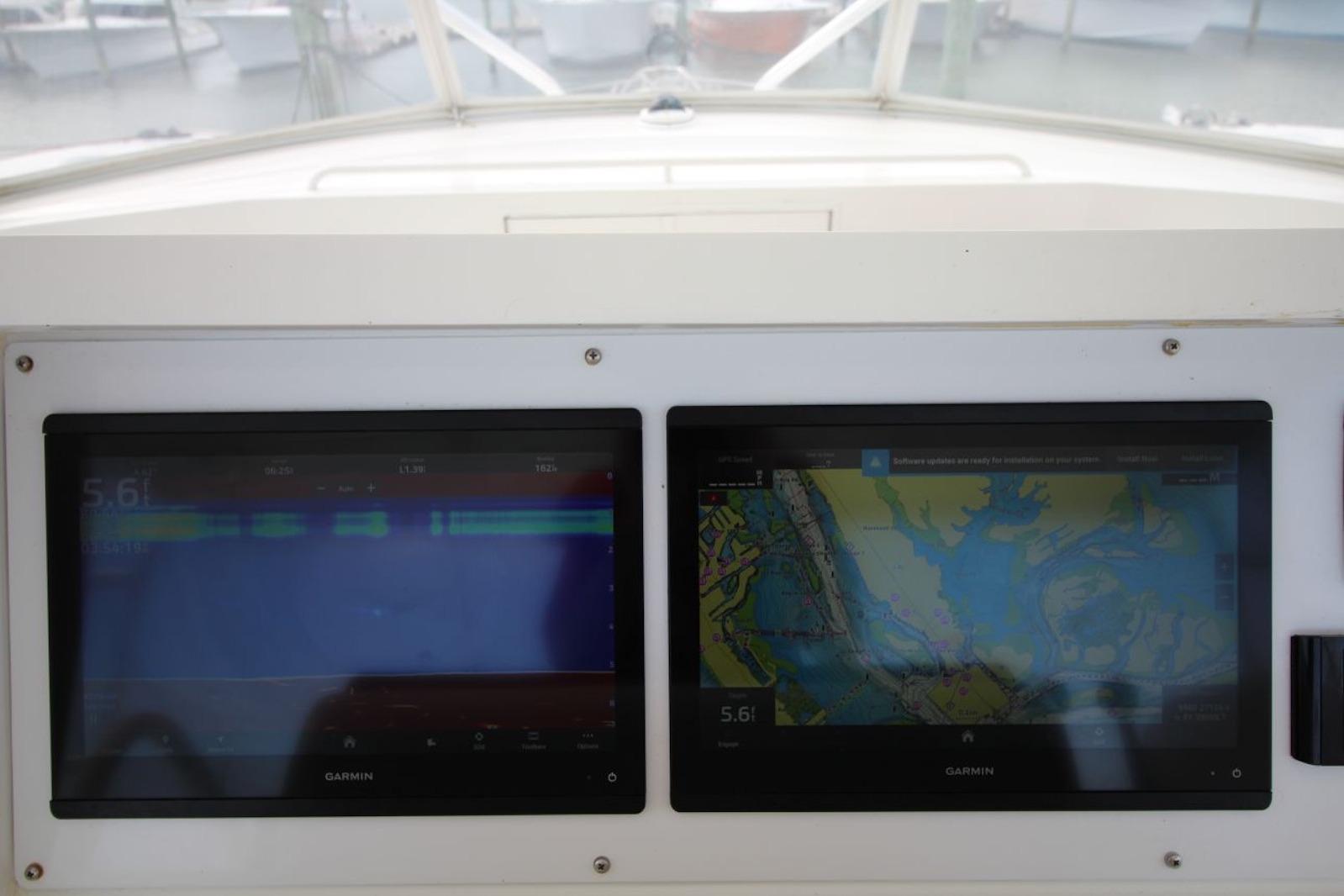 Garmin navigation screens on 2003 Hatteras 60 Convertible yacht dashboard.