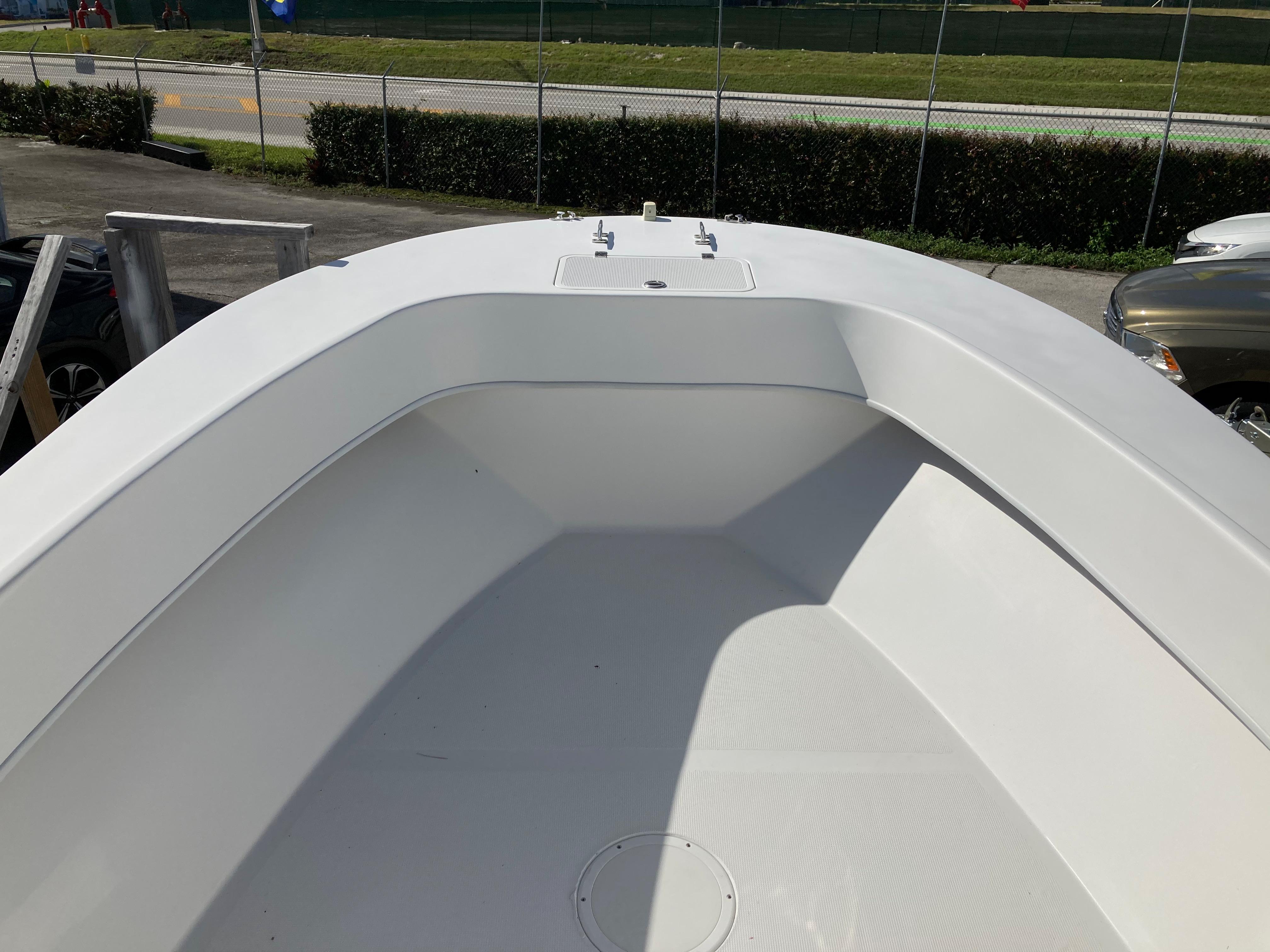 2021 Dusky 252 T boat deck, white interior, outdoor setting.