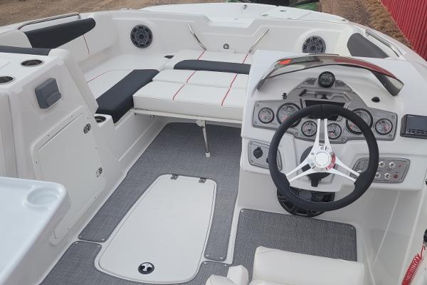 2024 Tahoe 1950 boat interior with steering wheel, seating, and control panel.