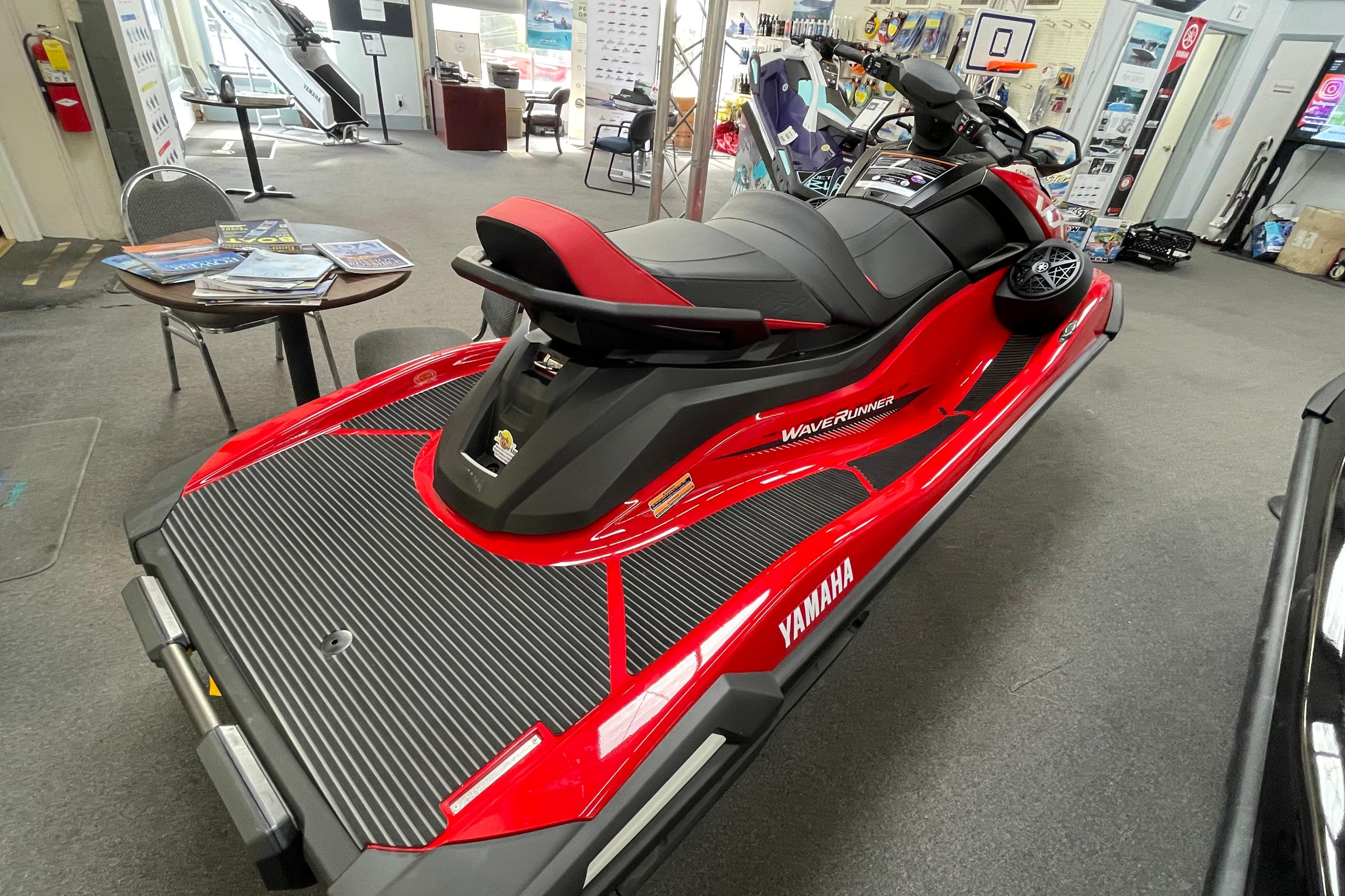 2026 Yamaha WaveRunner VX Cruiser in showroom, red and black design, side view.