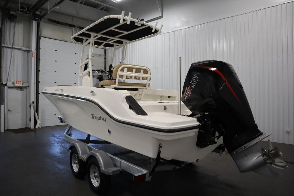 2026 Bayliner Trophy T20CC boat in a garage, featuring a powerful outboard motor.