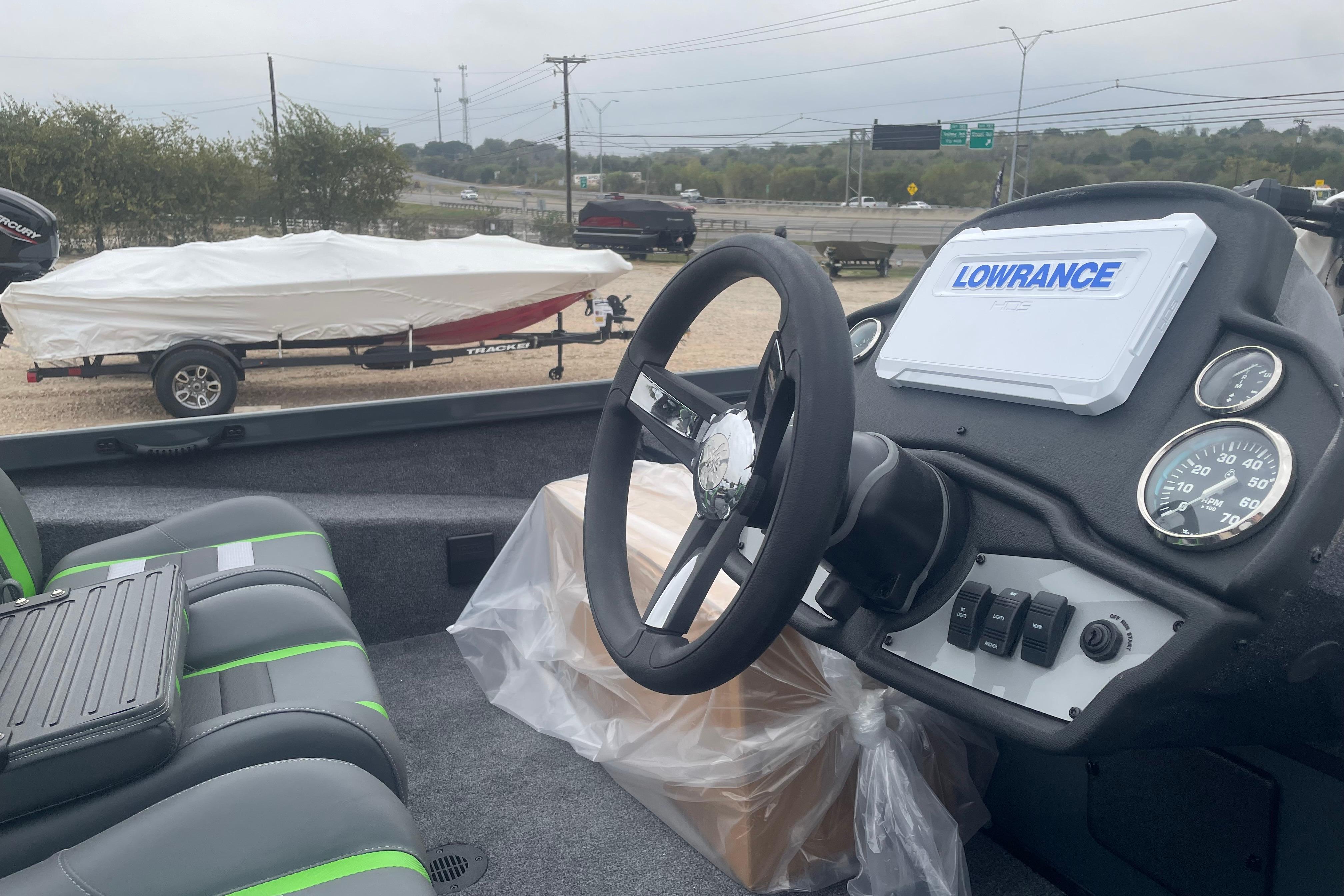 2026 Ranger RT188 boat interior with Lowrance system and covered boat in background.