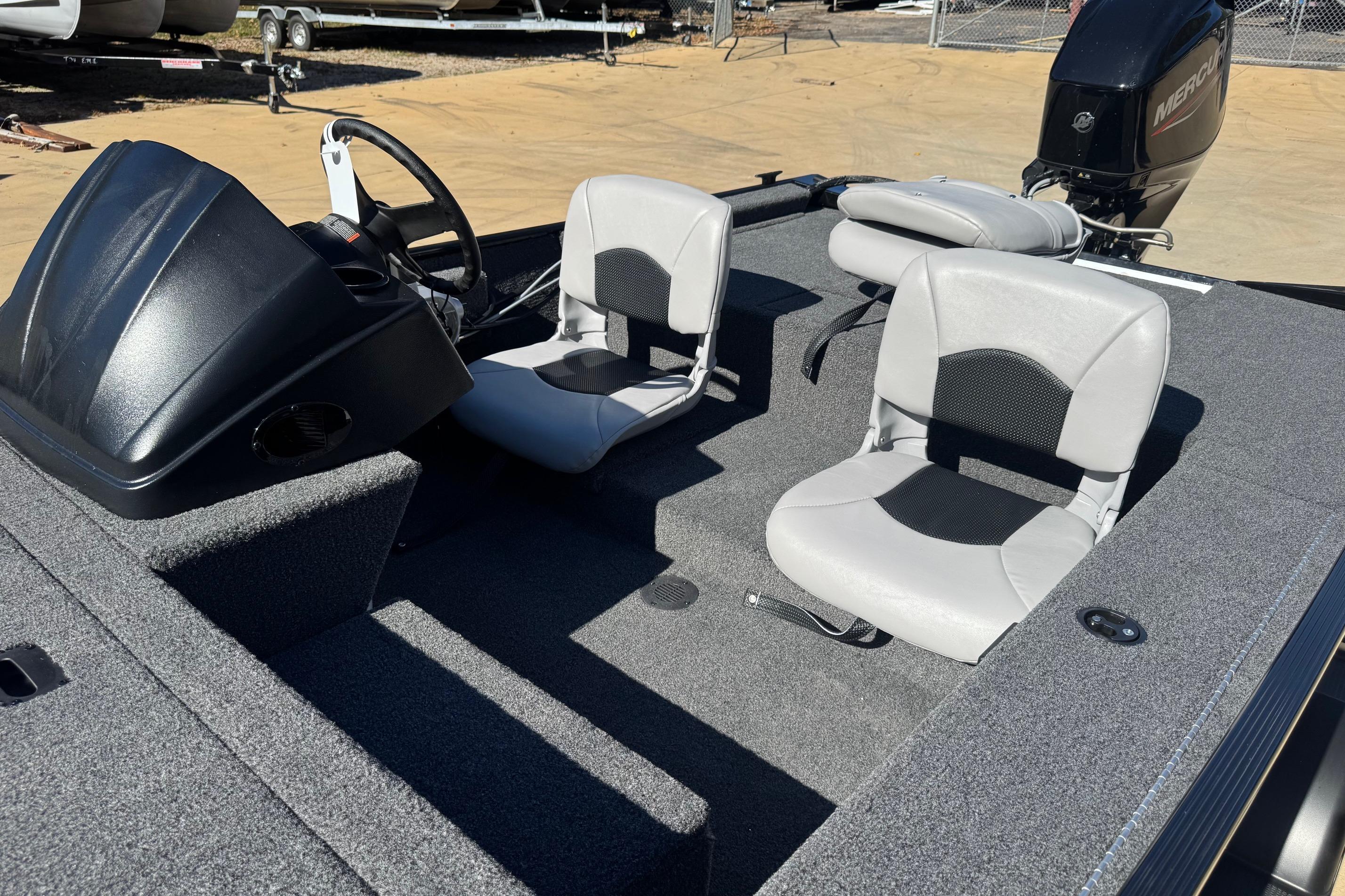 2026 Crestliner 1600 Storm boat interior with steering console and two seats.