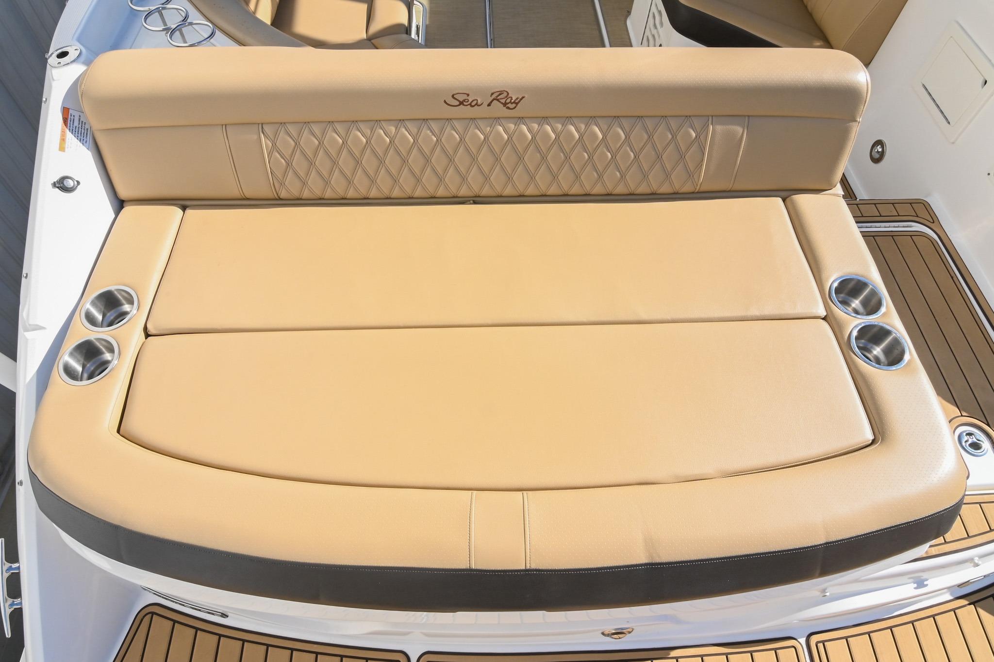 2020 Sea Ray SLX 250 boat with tan cushioned seating and cup holders.