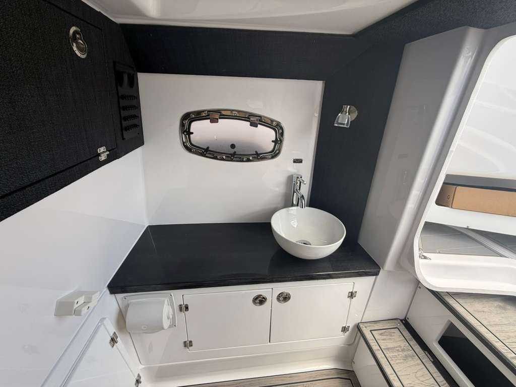 Interior of a modern boat cabin with a sink and window.