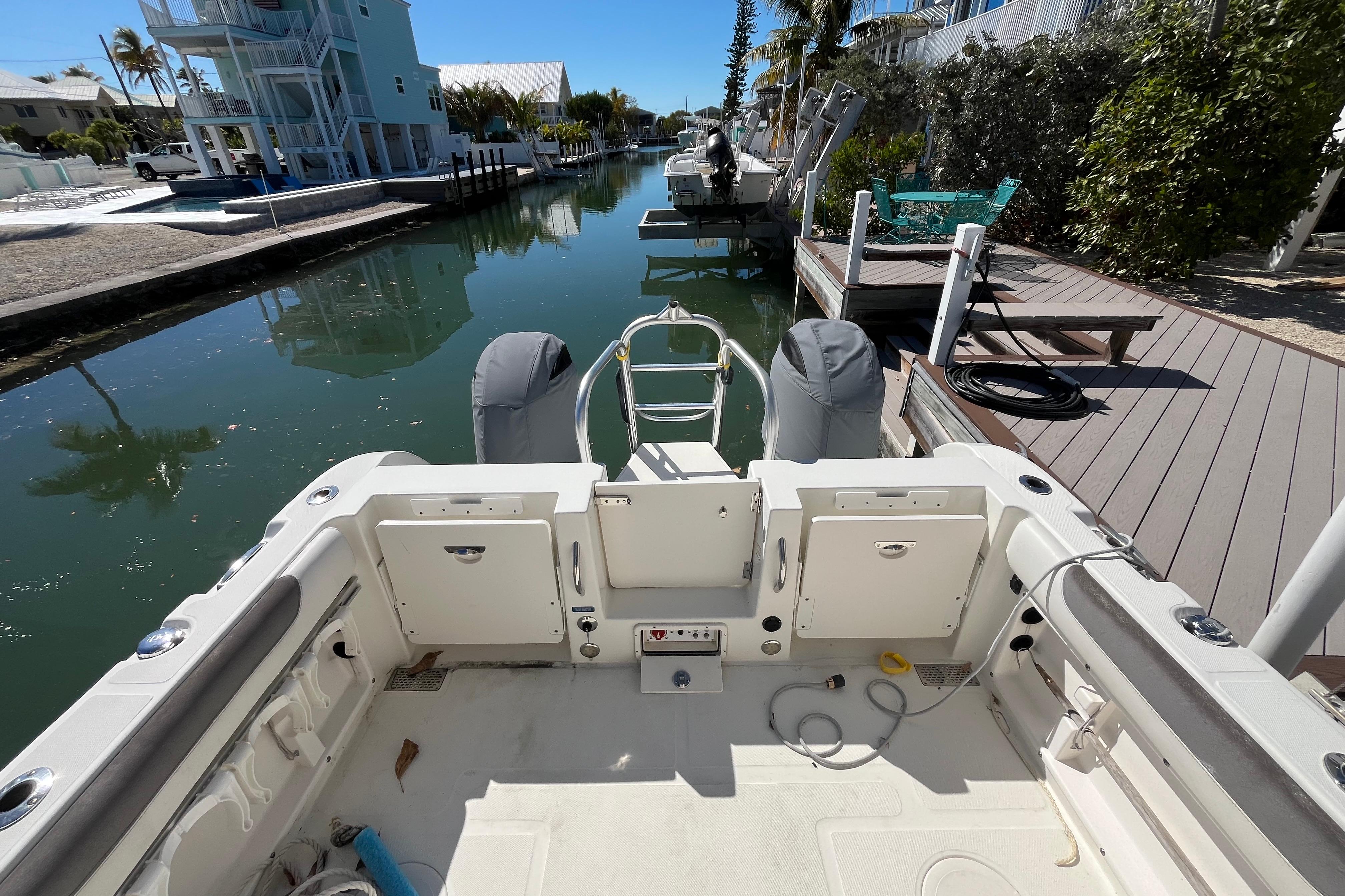 2017 World Cat 255 DC boat docked in a serene canal setting.