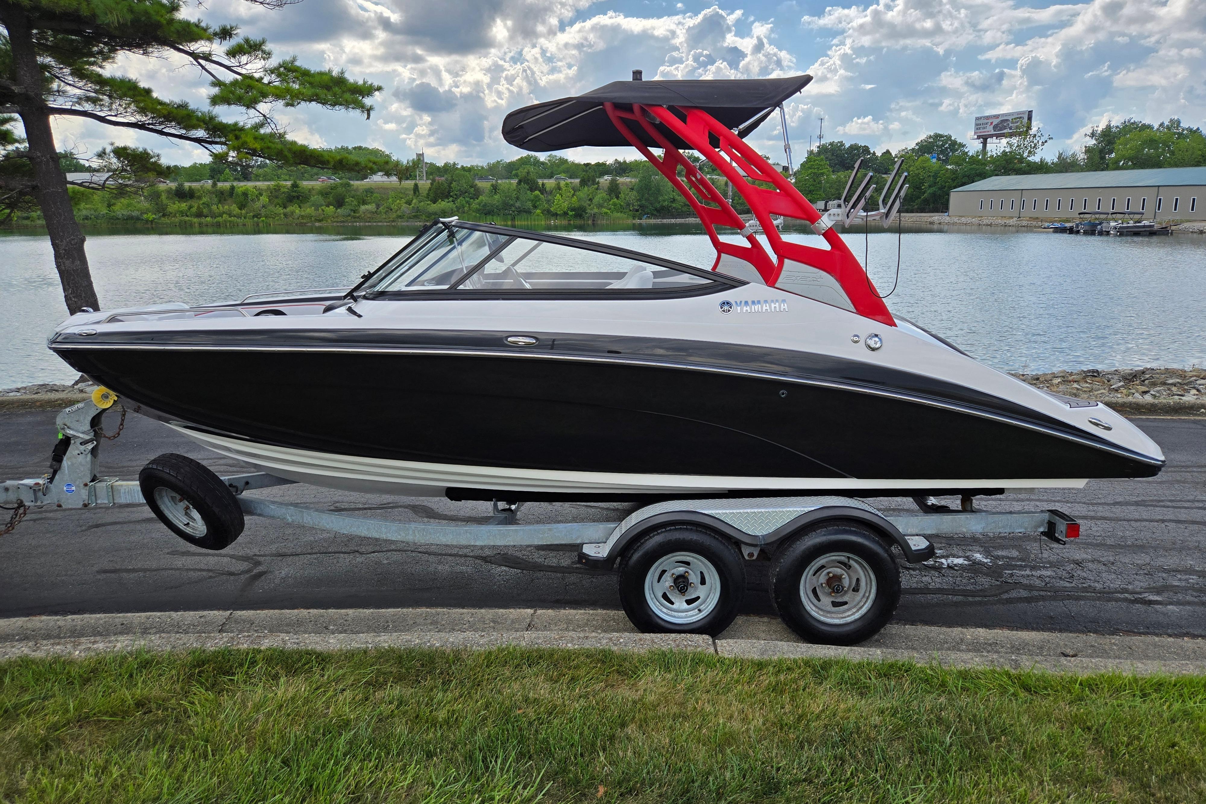 2018 Yamaha Boats 212X on trailer by a scenic lakeside.