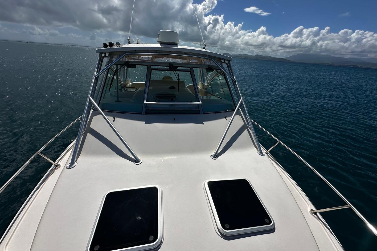 2006 Grady-White Express 360 boat on open water under a cloudy sky.