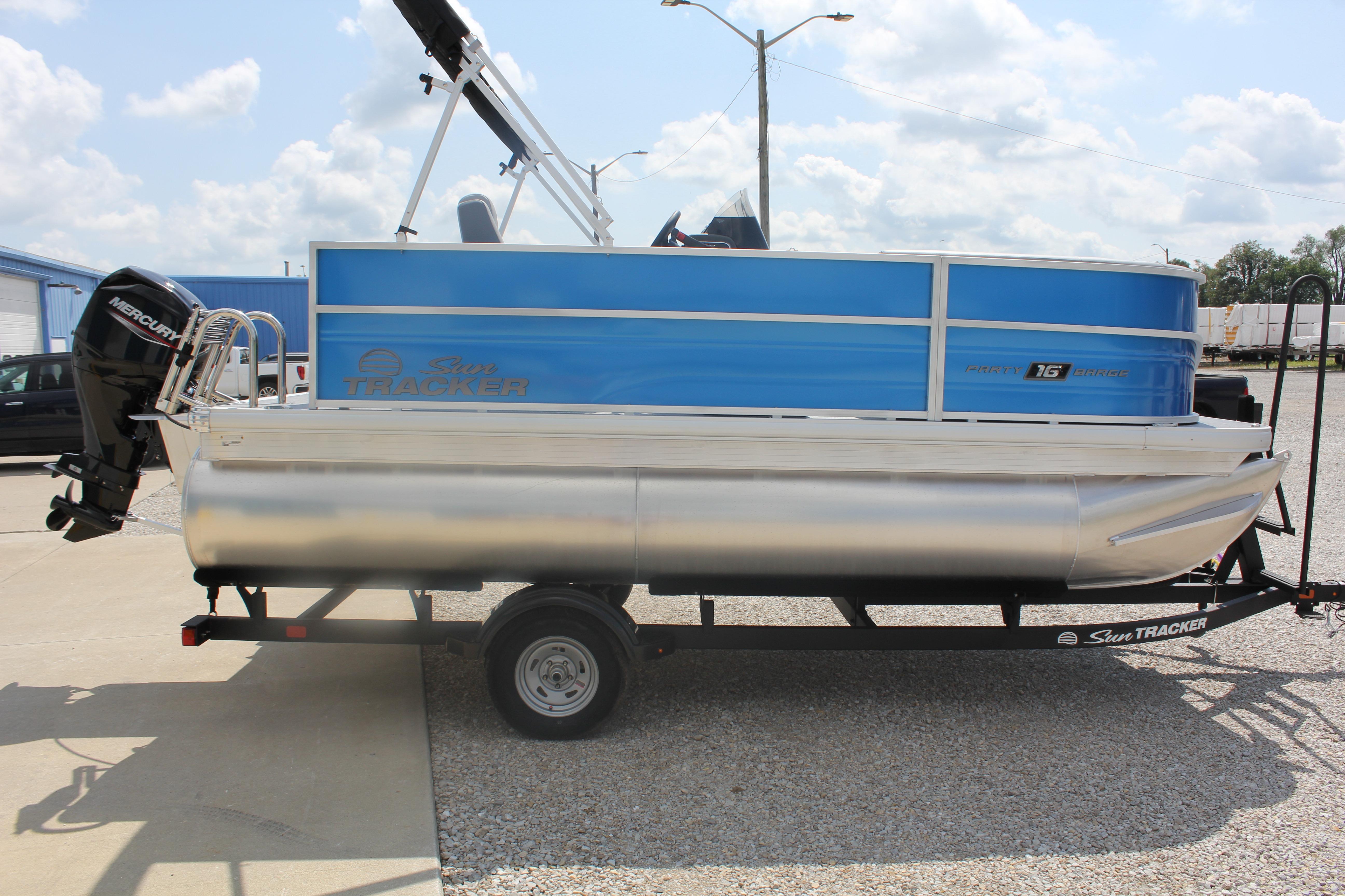 2026 Sun Tracker Party Barge 16 DLX pontoon boat on trailer, side view.
