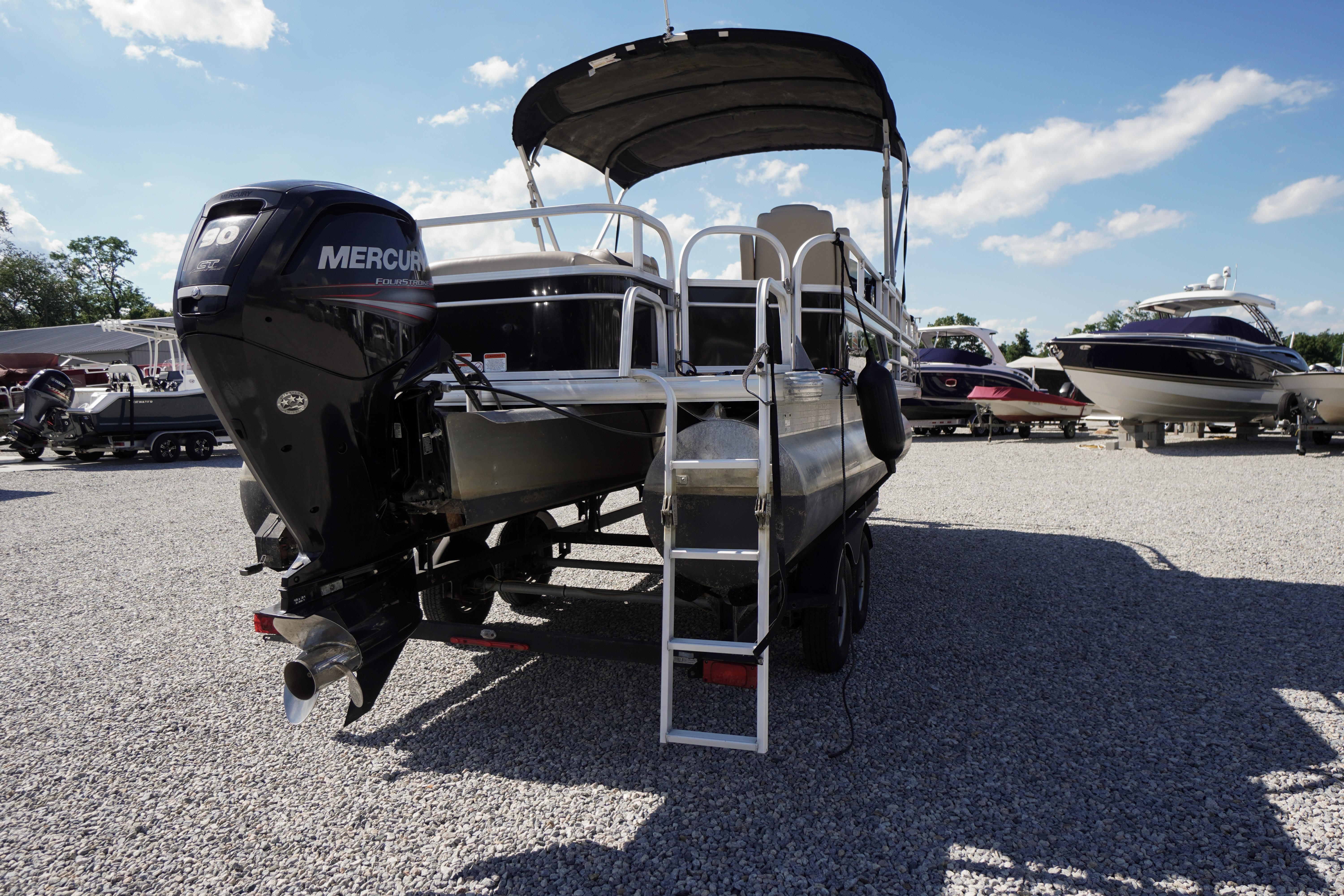 2019 SUNTRACKER Fishin' Barge 22 DLX pontoon boat with Mercury engine on gravel lot.