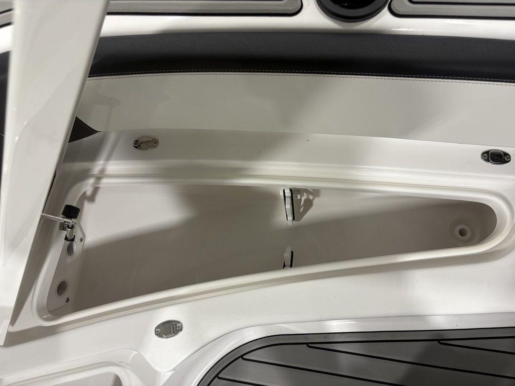 Open storage compartment on 2026 Tidewater 2700 CB boat, featuring sleek interior design.