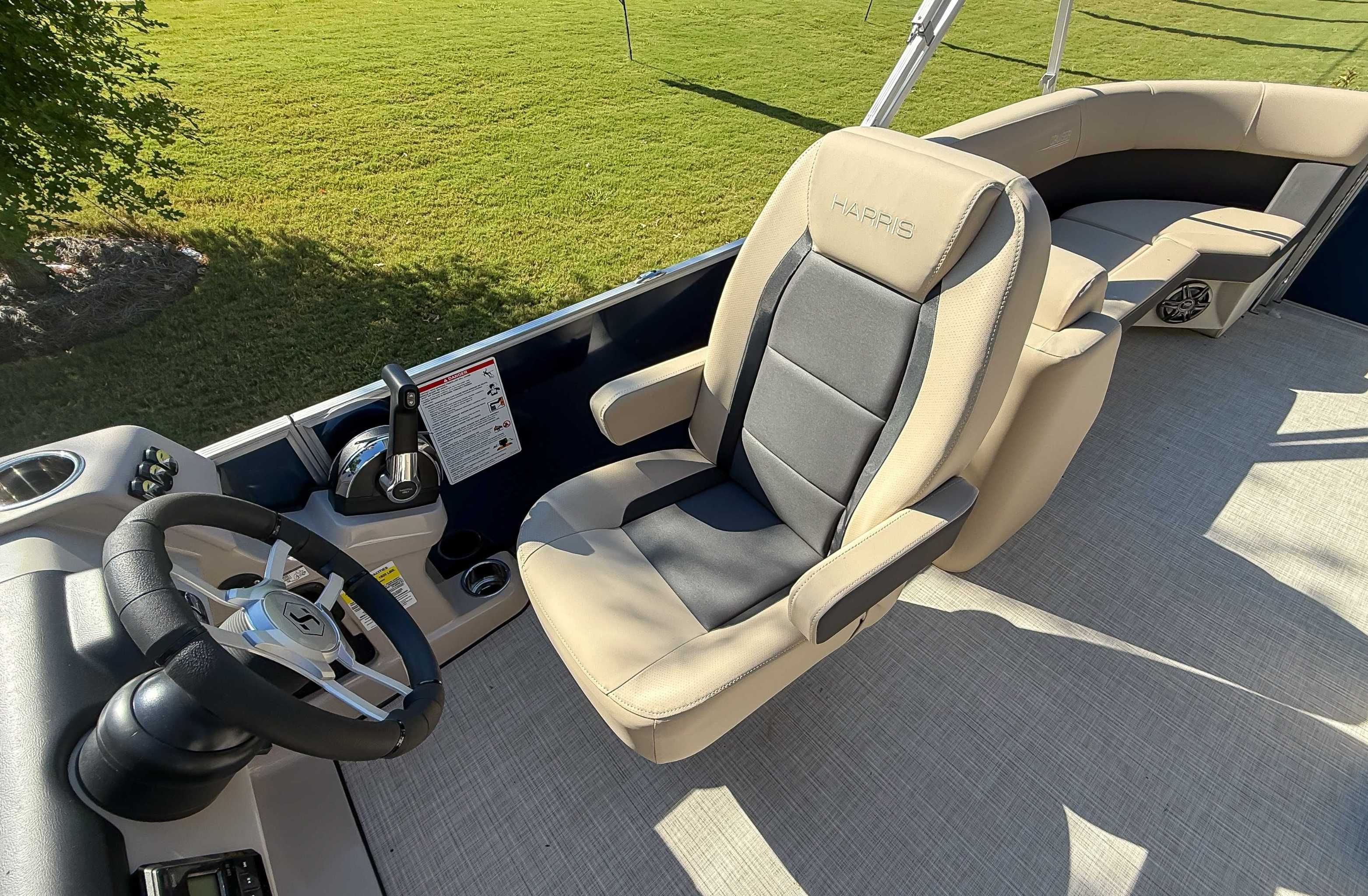 Interior of 2025 Harris Cruiser 250 CWDH with steering wheel and seat.