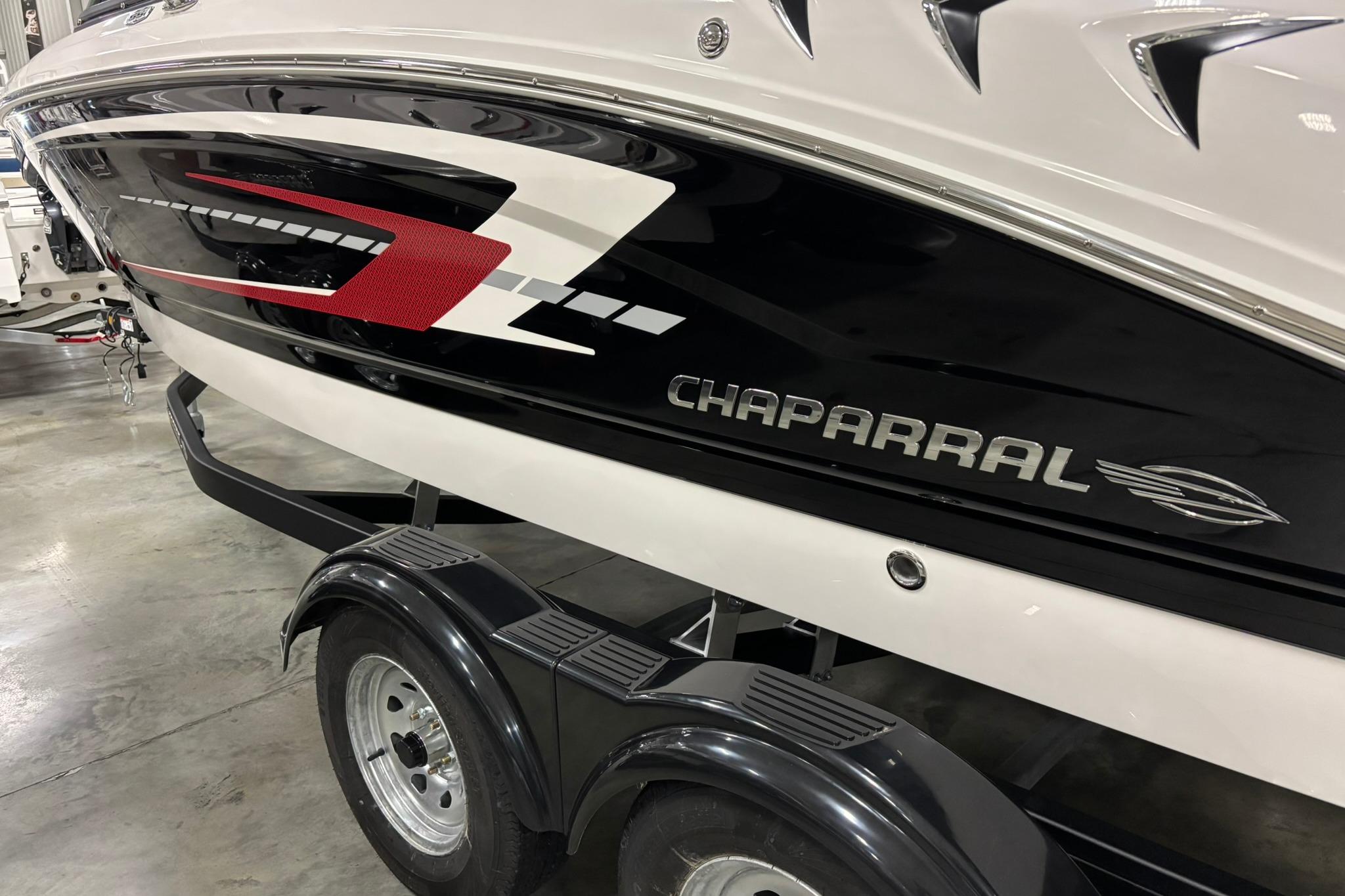 2026 Chaparral 21 SSi OB boat on trailer, sleek black and white design.