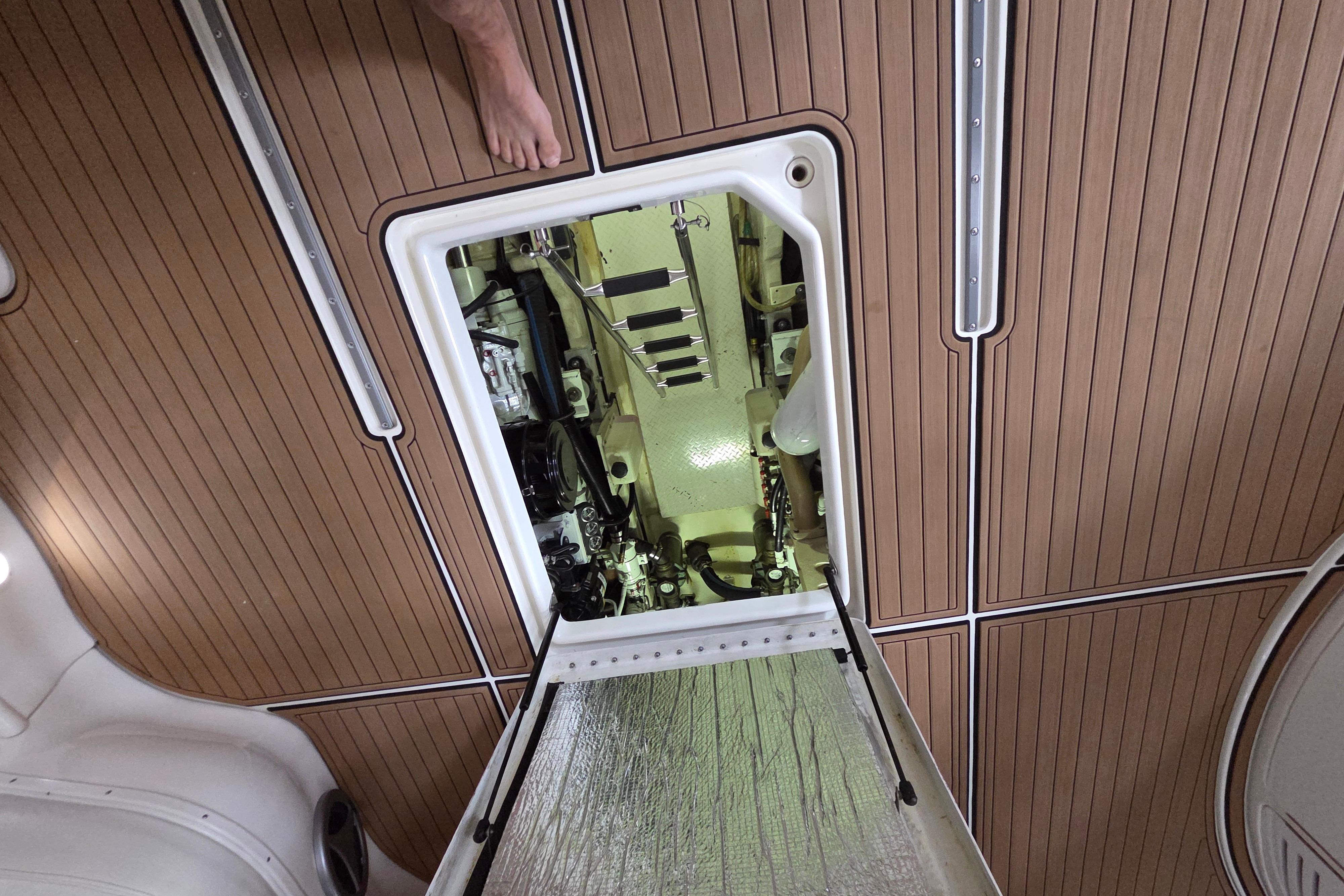 Engine compartment of a 2000 Sea Ray Sundancer 540 yacht with wooden deck flooring.