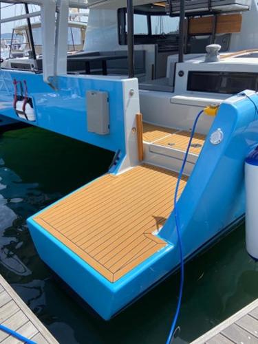 2025 Vision 444 yacht with blue hull and teak deck at marina.