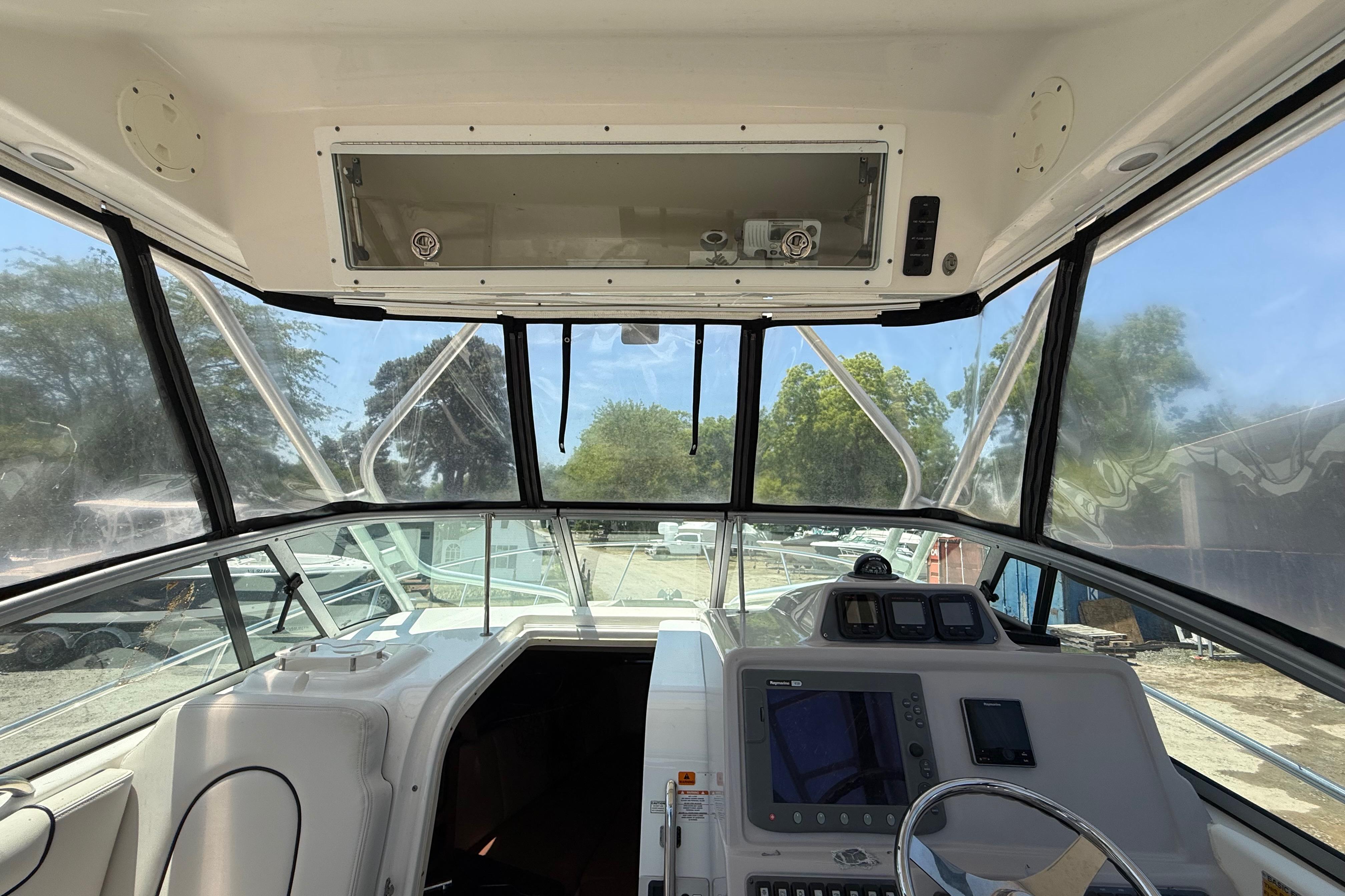 2007 Robalo R305 Walkaround boat cockpit with steering wheel and navigation equipment.