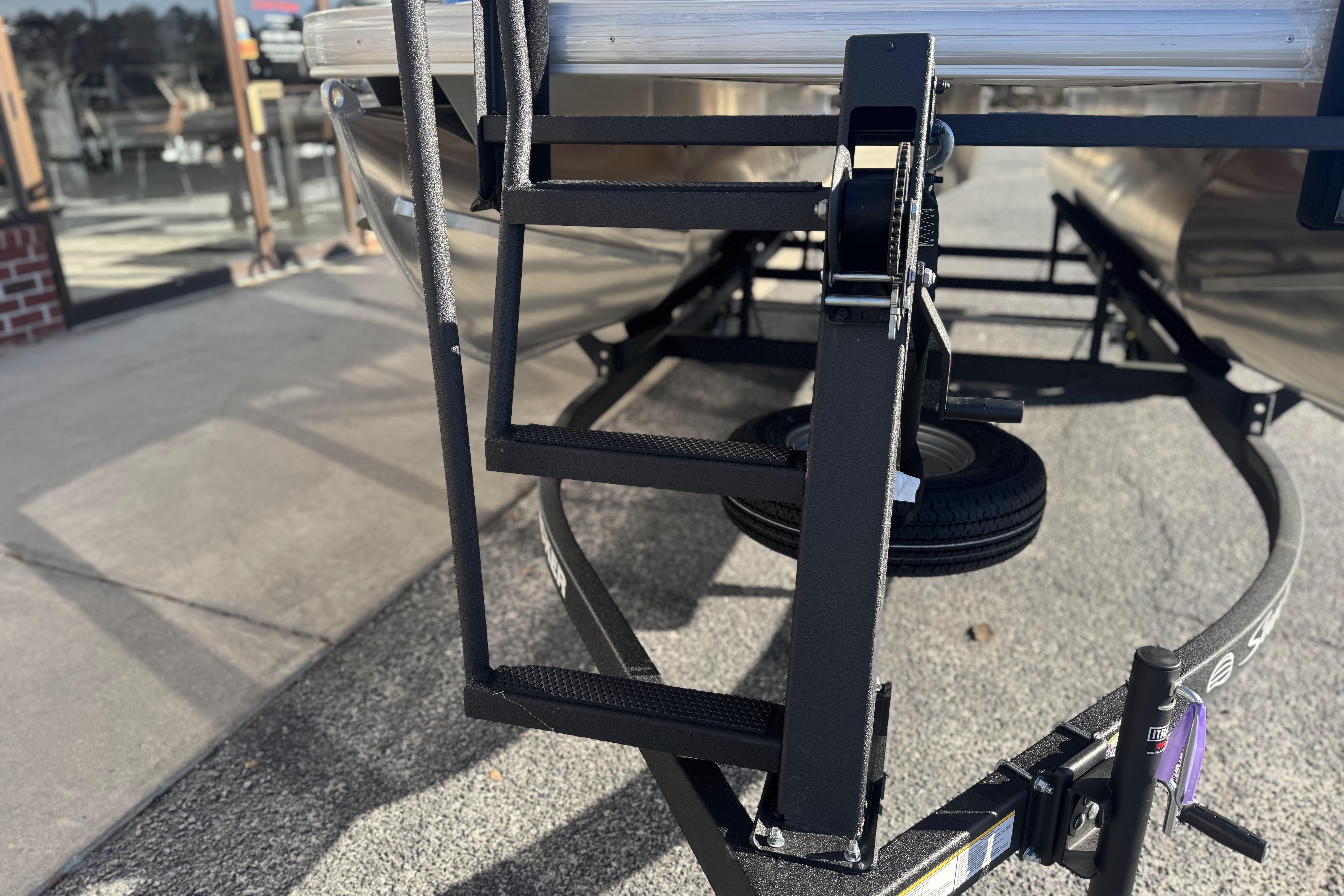 2026 Sun Tracker Party Barge 16 DLX trailer ladder and hitch detail.