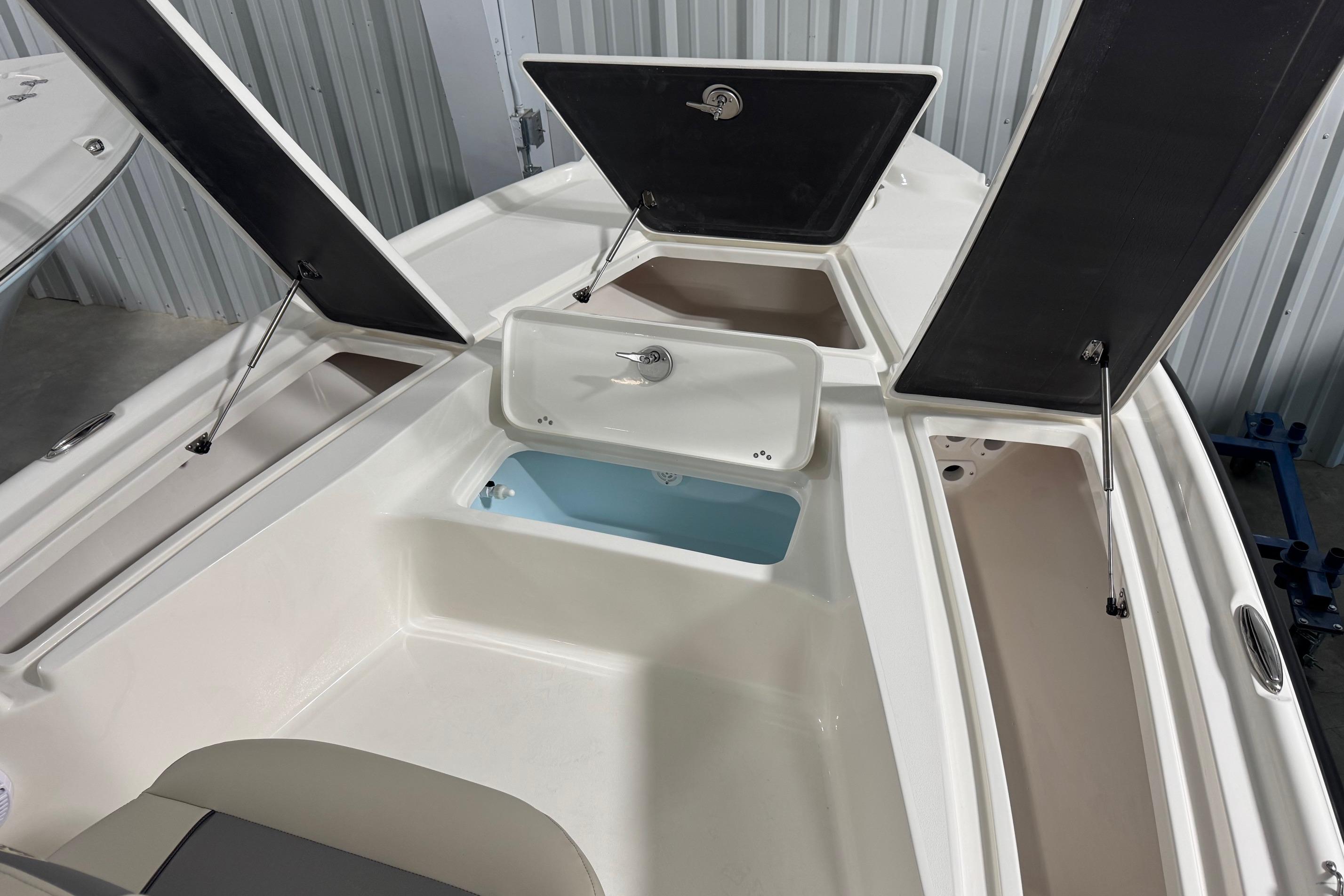 2026 Key West 210 Bay Reef boat storage compartments open, showcasing interior design.