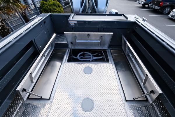 2024 Hewescraft 250 Explorer boat interior with storage compartments and diamond plate flooring.