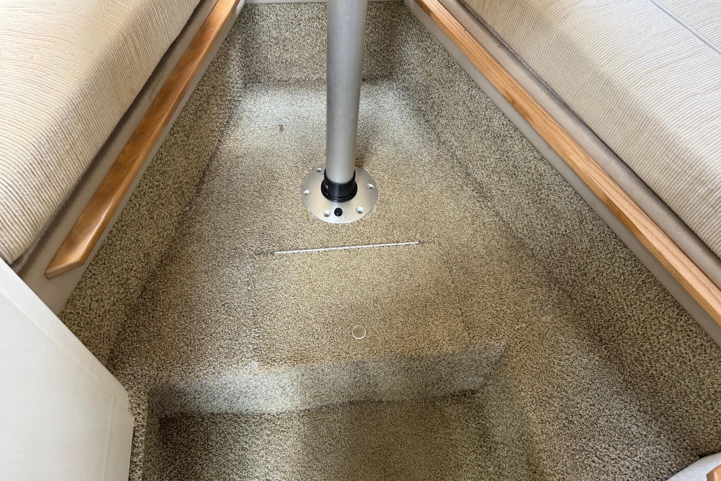 Interior cabin of 2000 Maxum 2400 SCR boat with carpeted flooring.