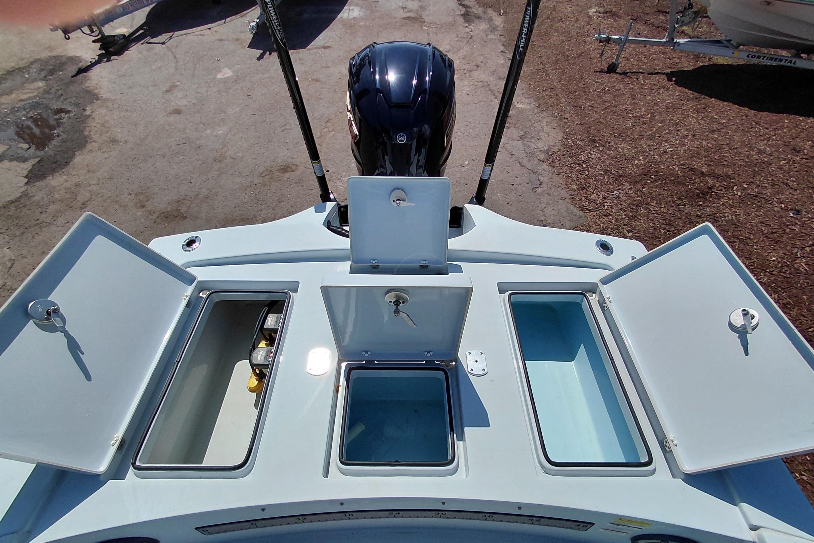 2022 Pathfinder 2300 HPS boat with open storage compartments and outboard motor.