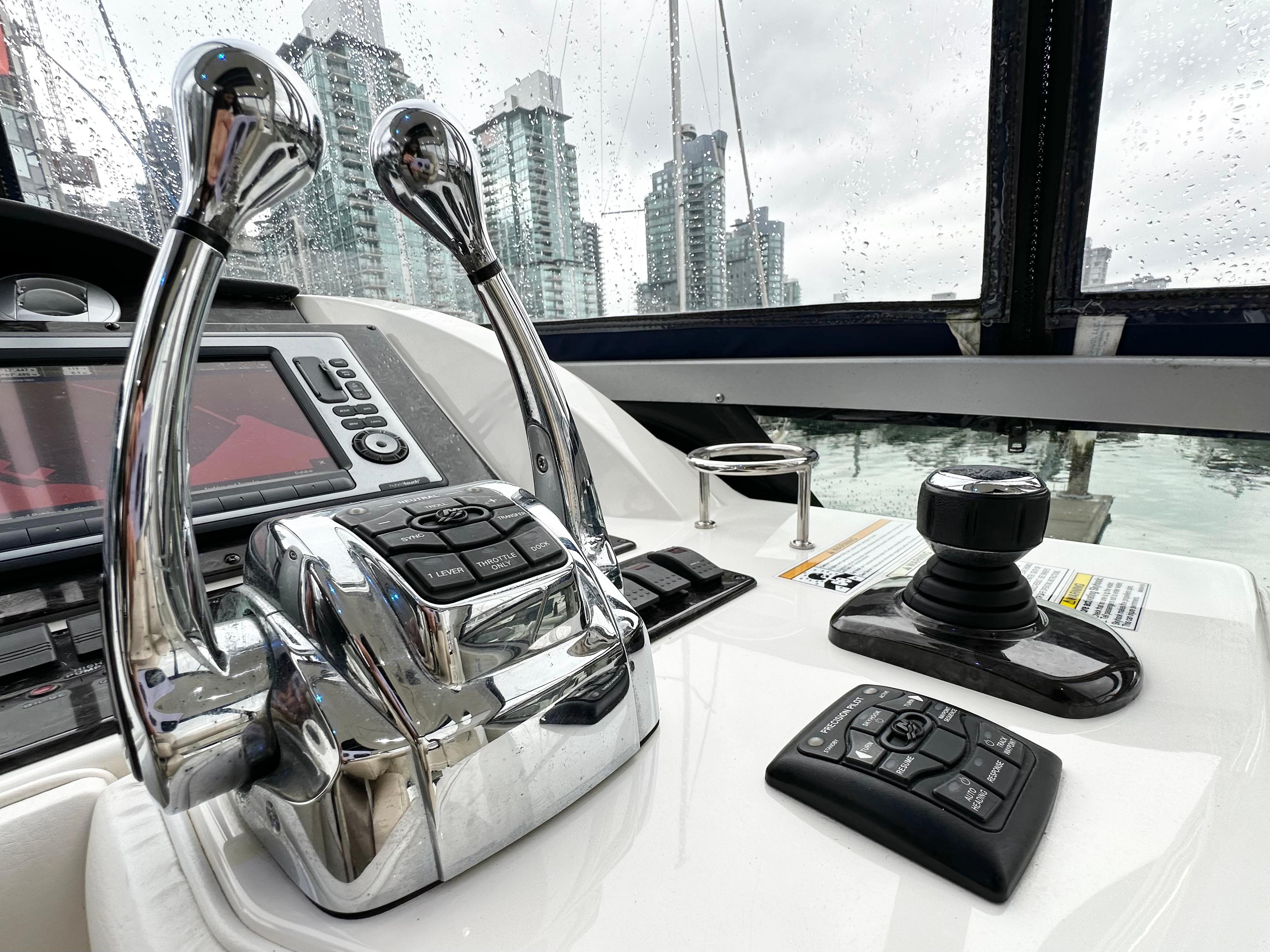 2012 Sea Ray 450 Sedan Bridge helm with cityscape view.