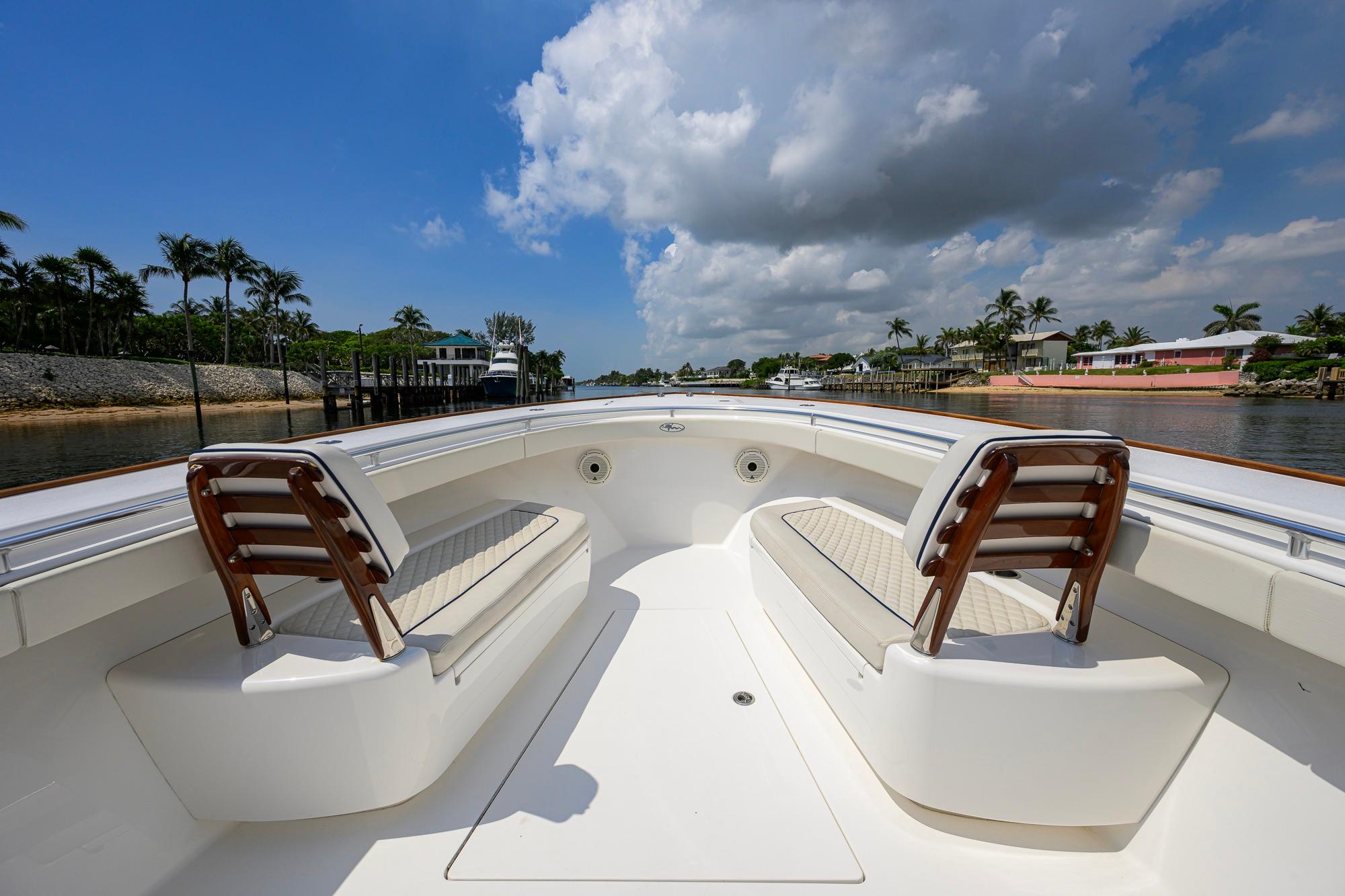 2020 Valhalla Boatworks V-41 interior with seating, under a partly cloudy sky.