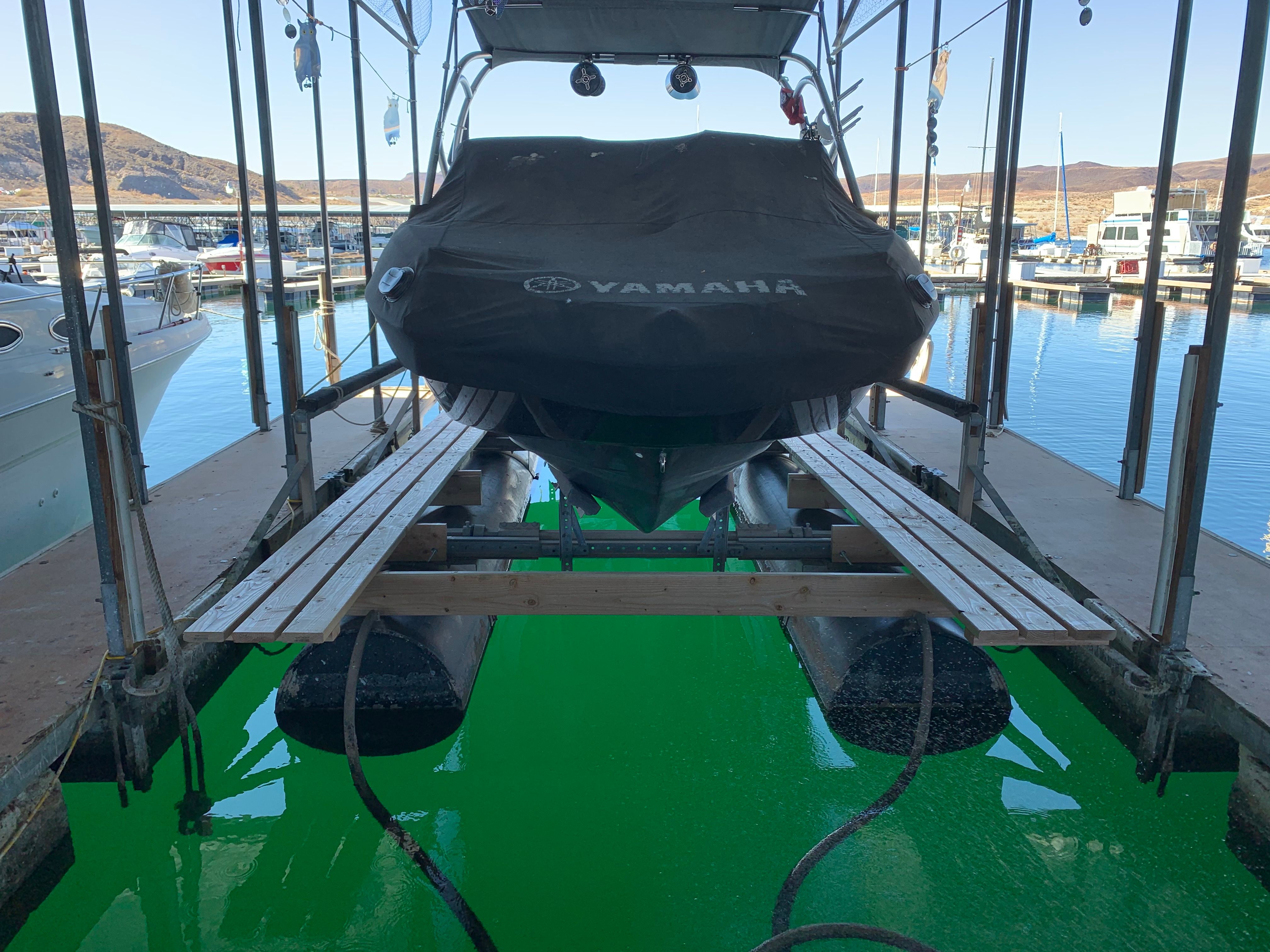 Yamaha AR240 HO boat on a lift in the marina.