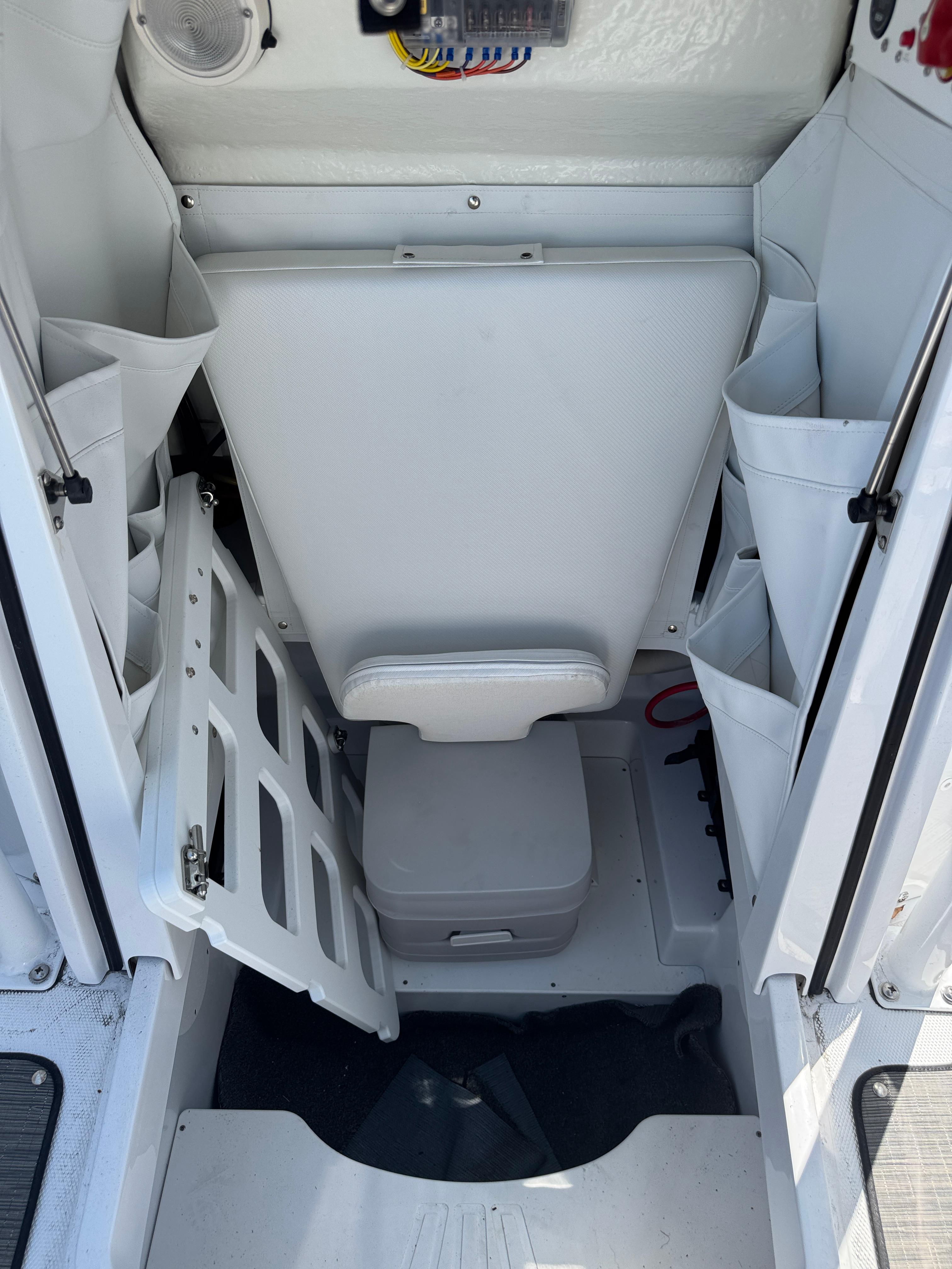 2025 Wellcraft 222 Fisherman boat interior with storage compartments and seating.