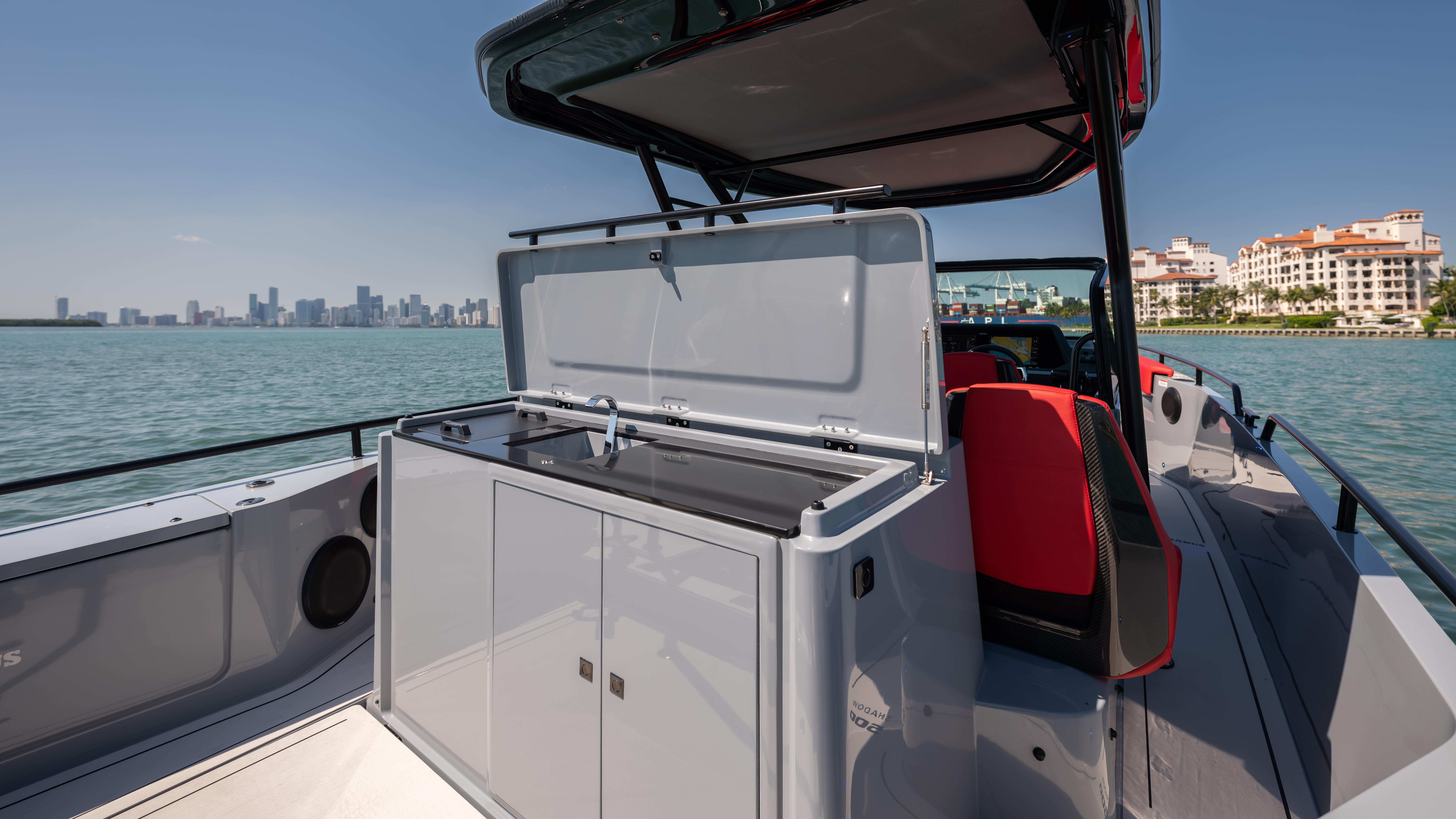 2023 BRABUS Shadow 500 T-Top boat with open storage, city skyline in background.