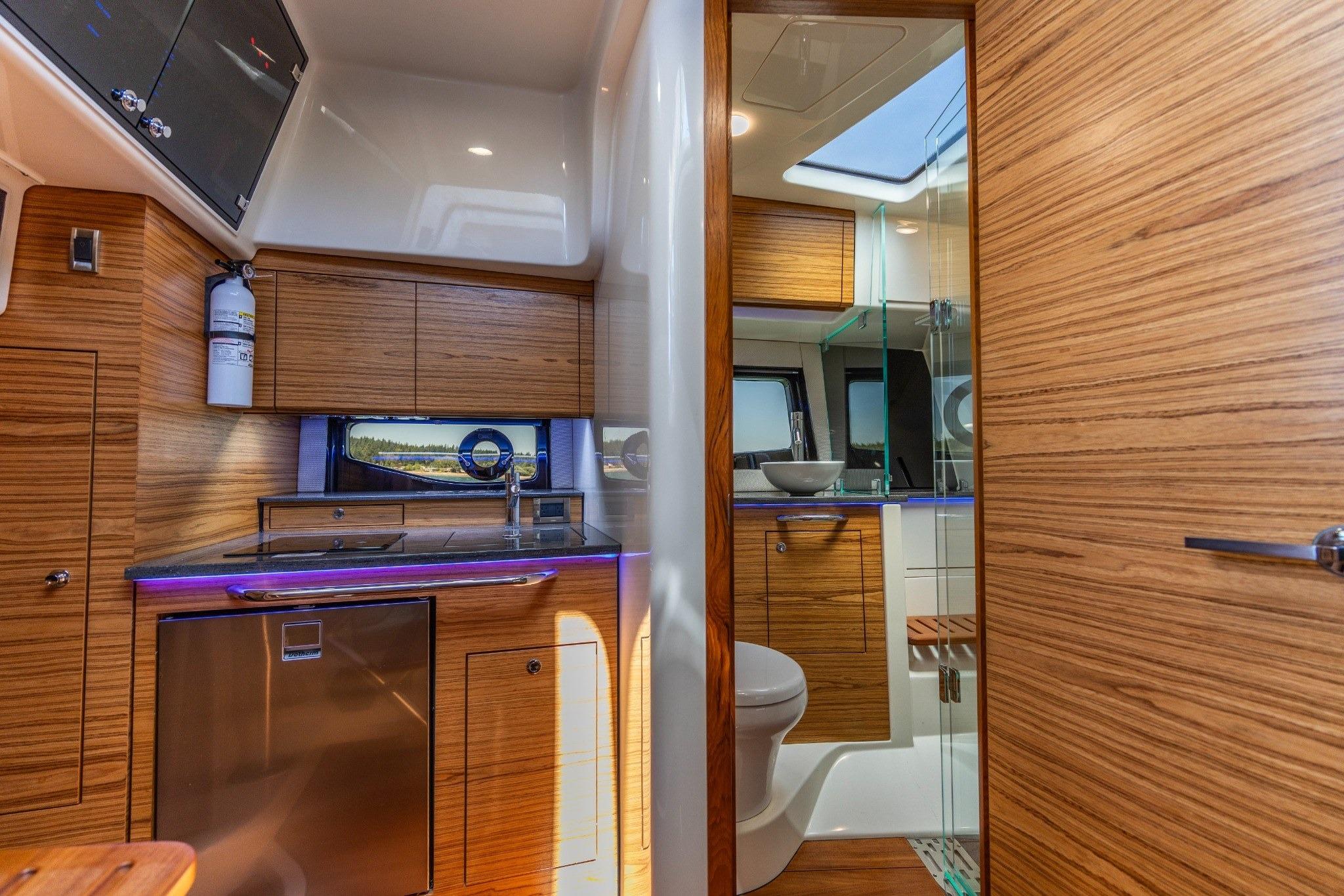Interior of 2023 Boston Whaler 405 Conquest, featuring modern kitchen and bathroom design.