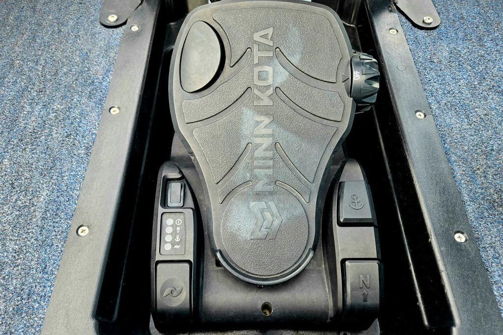 Minn Kota foot pedal on 1996 Champion 181 SX boat, featuring control buttons and textured surface.