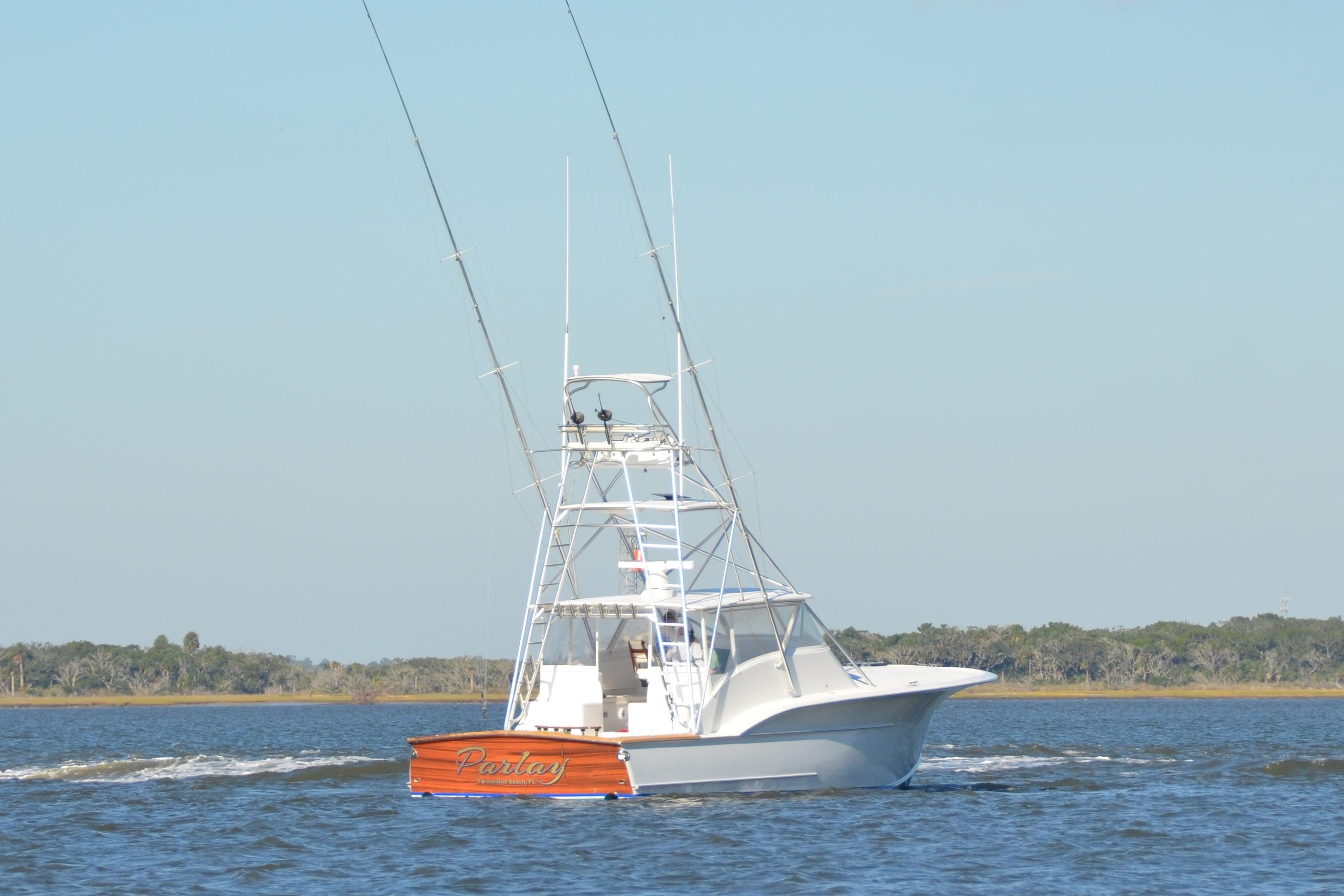 2006 Custom Carolina Heritage Express boat cruising on open water.