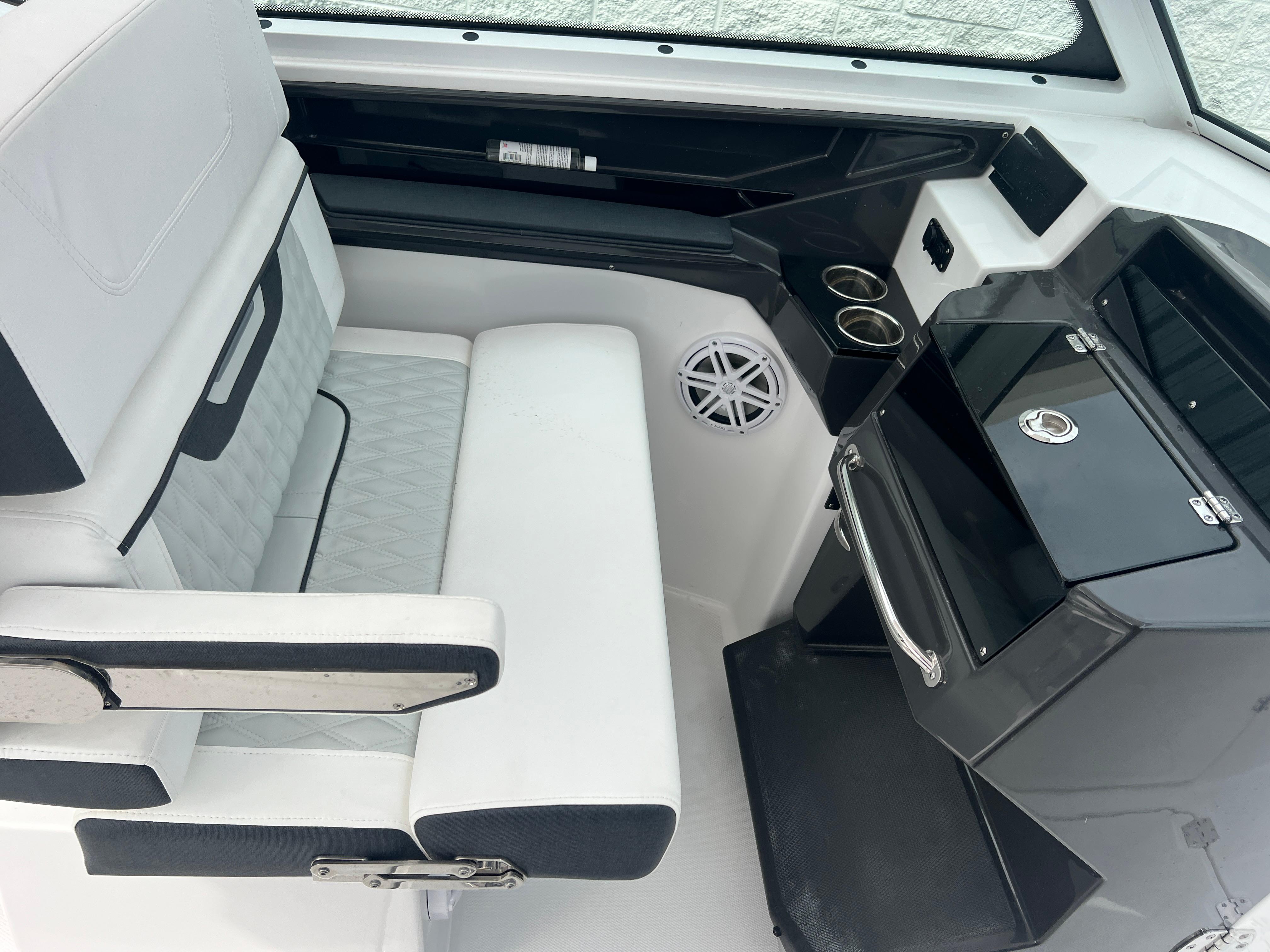 2024 Blackfin 272 DC boat interior with seating and console, featuring modern design and amenities.