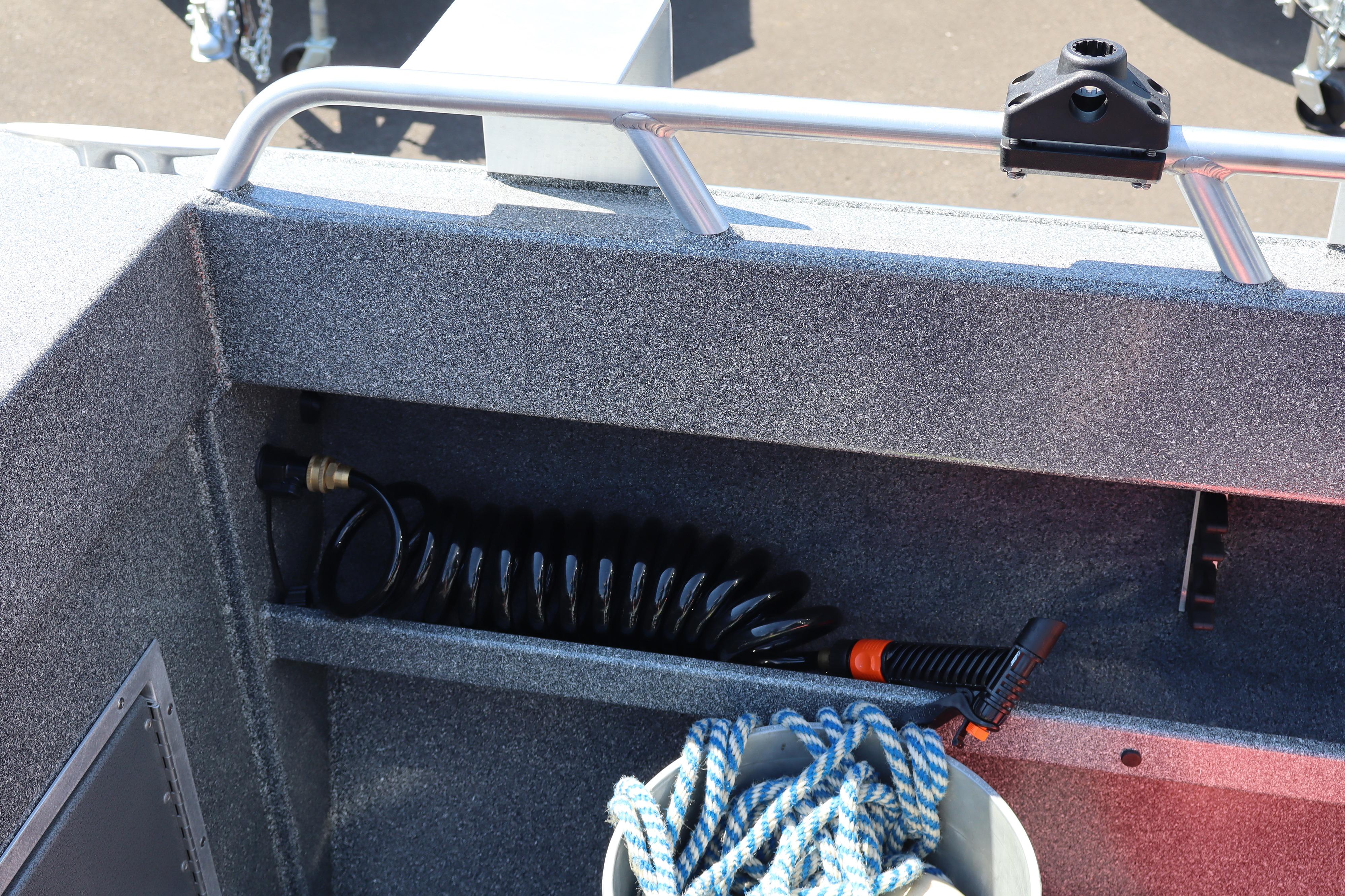 2025 NorthRiver SEAHAWK boat interior with coiled hose and rope storage.