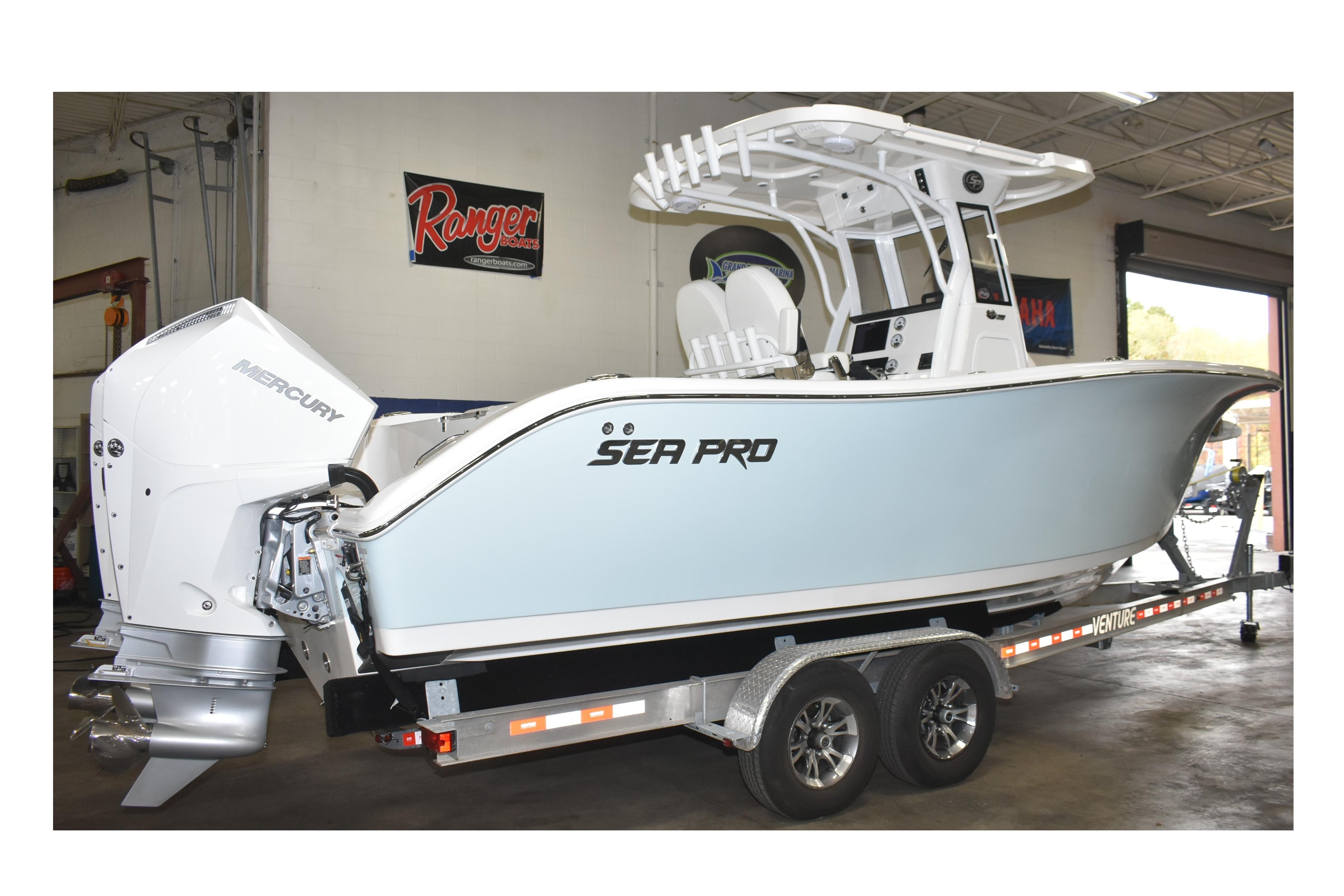 2025 Sea Pro 262 Offshore boat on trailer in garage setting.
