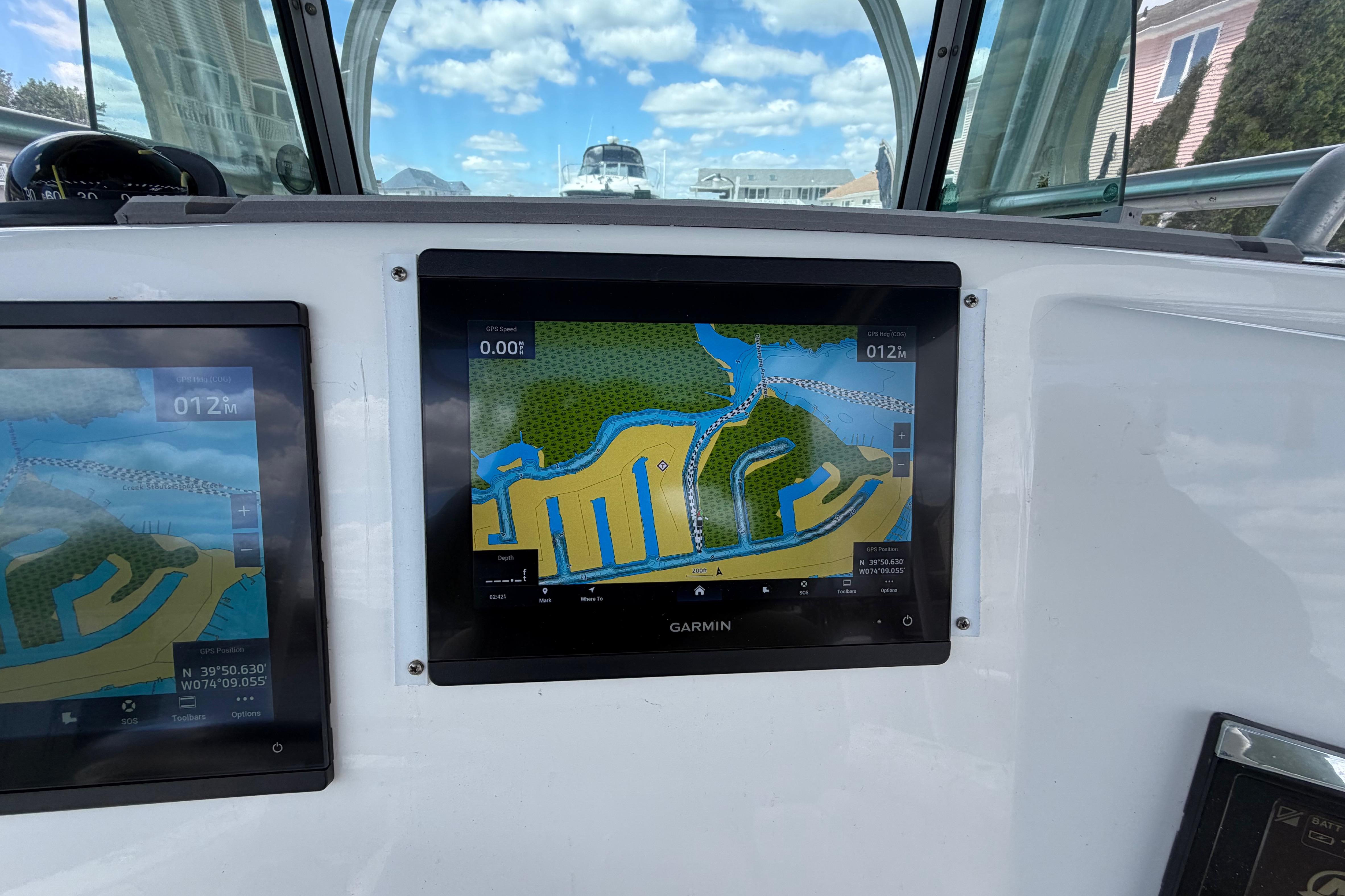 Garmin navigation screens on a 2017 Mako 284 Center Console boat, displaying nautical maps.