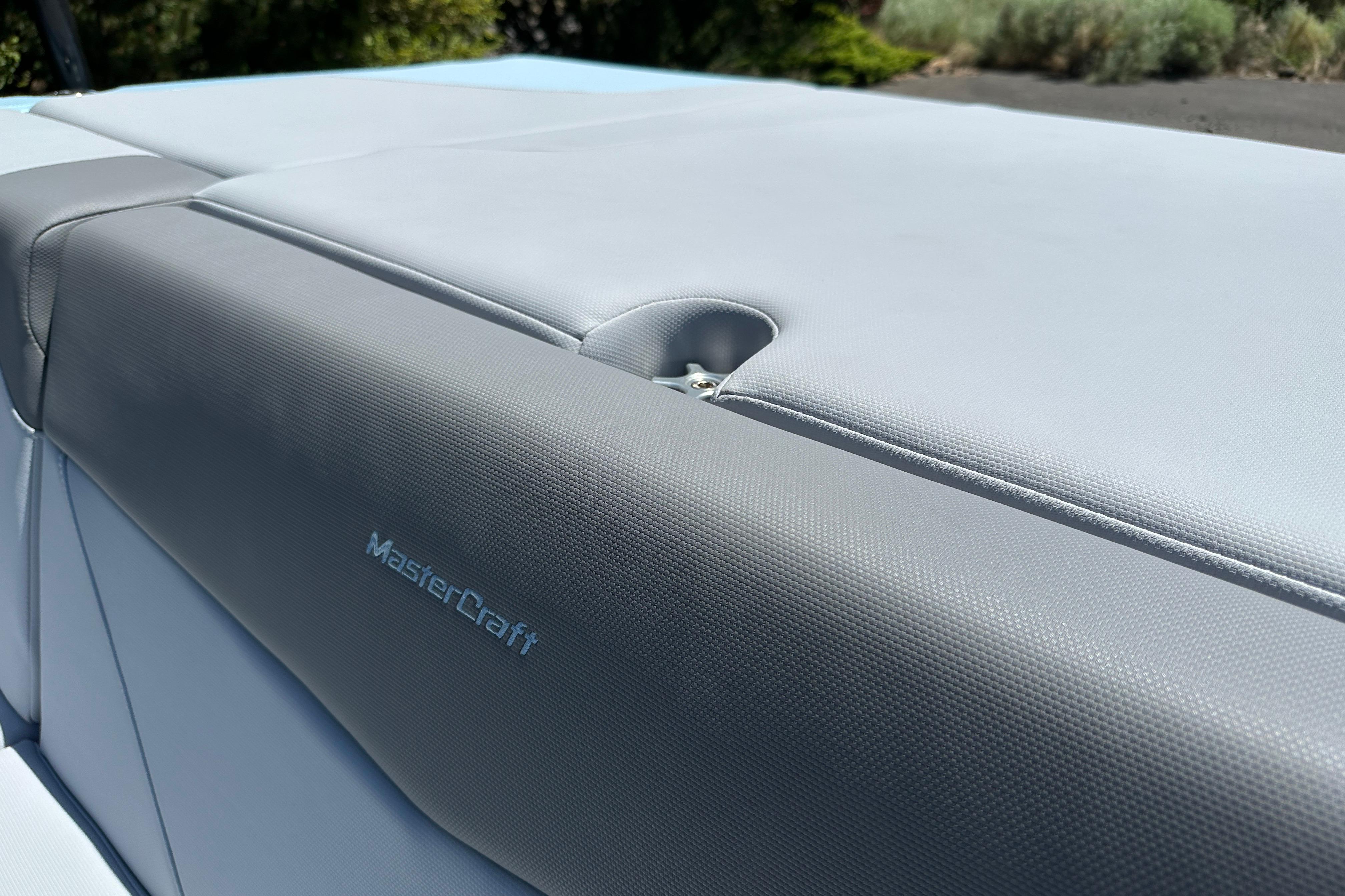 2023 MasterCraft NXT23 boat seat with gray upholstery and logo detail.