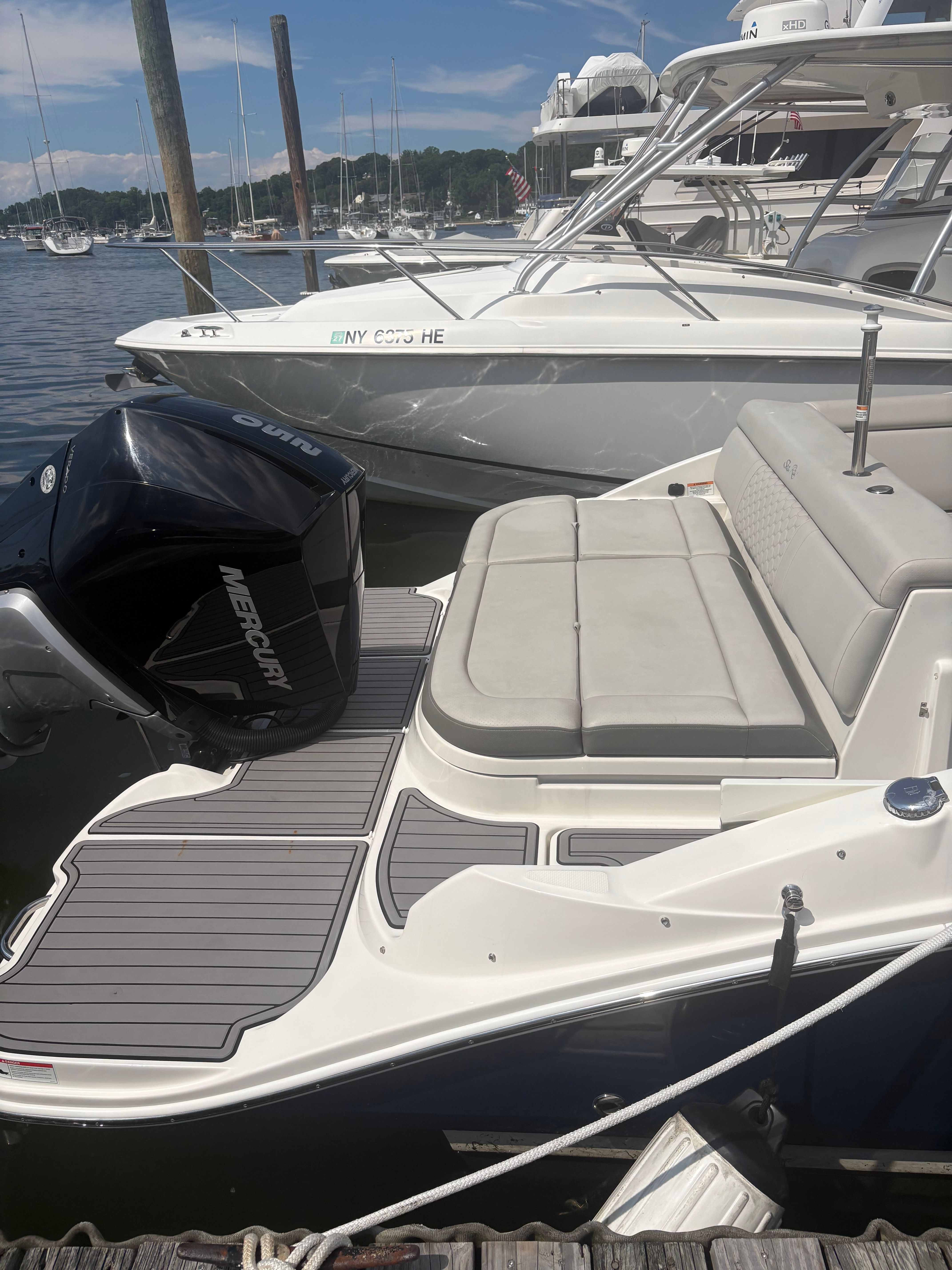A 2022 Sea Ray SDX 270 Outboard is docked. It features a spacious sun deck.