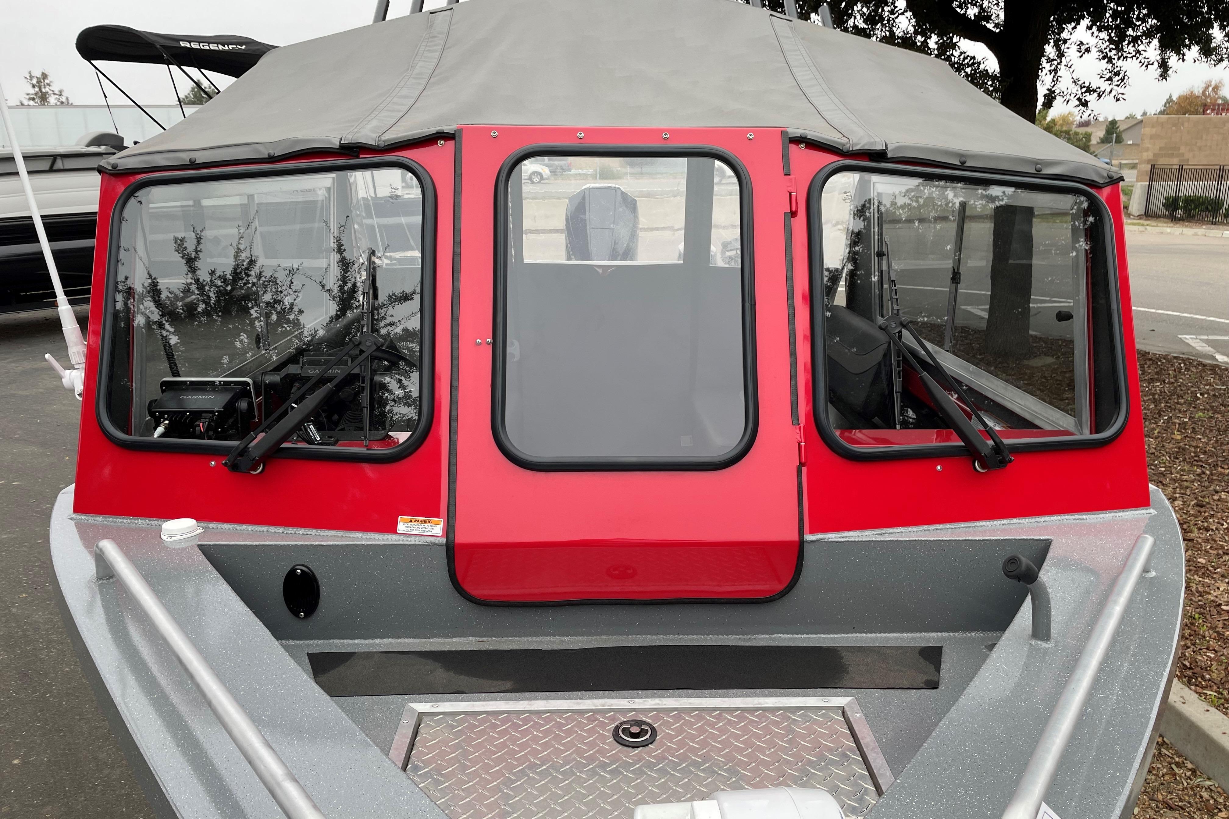 2024 Spartan 200 Astoria boat with red cabin and gray exterior.