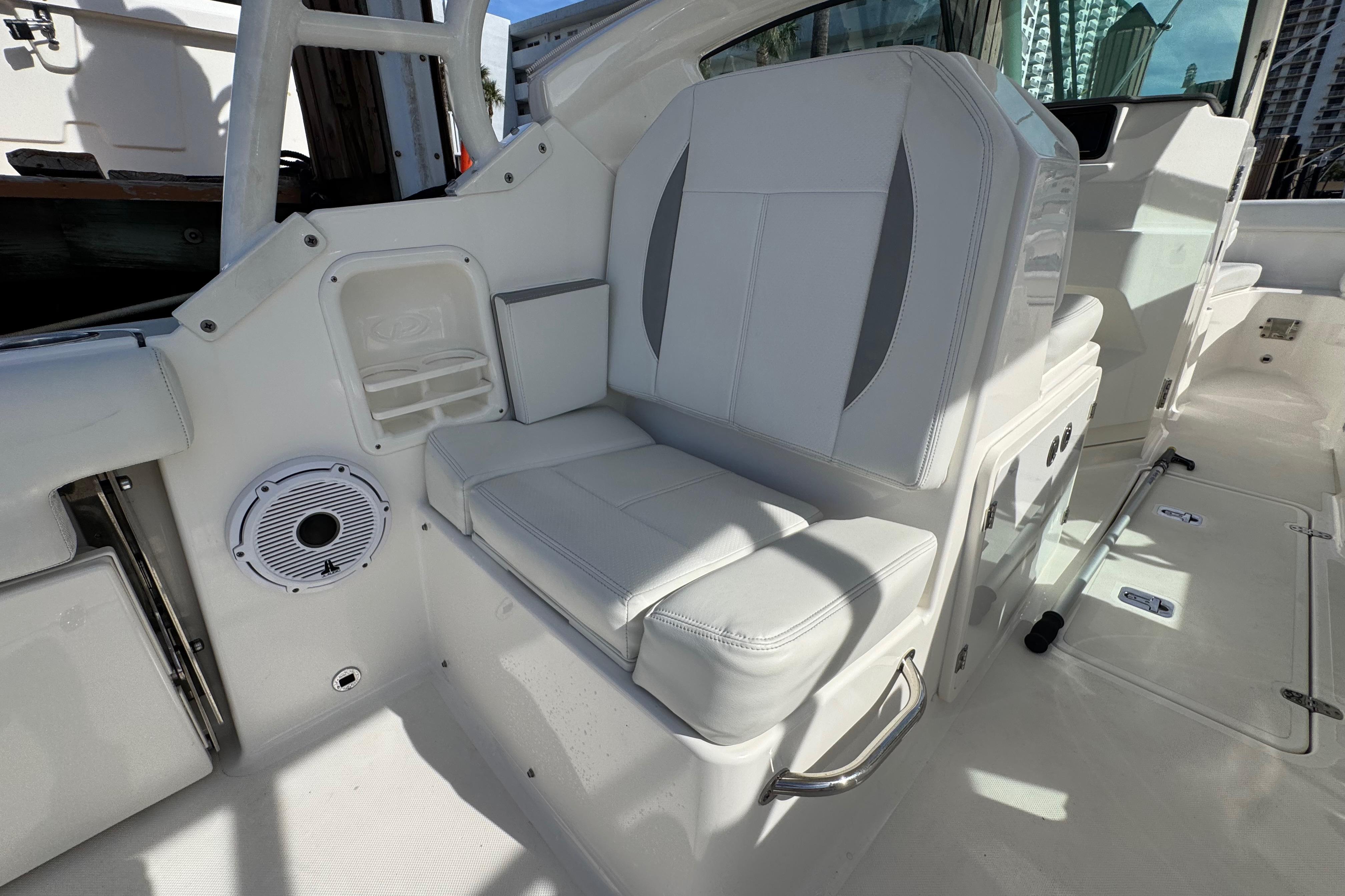2022 Pursuit DC 266 Dual Console boat interior with white seating and speaker.