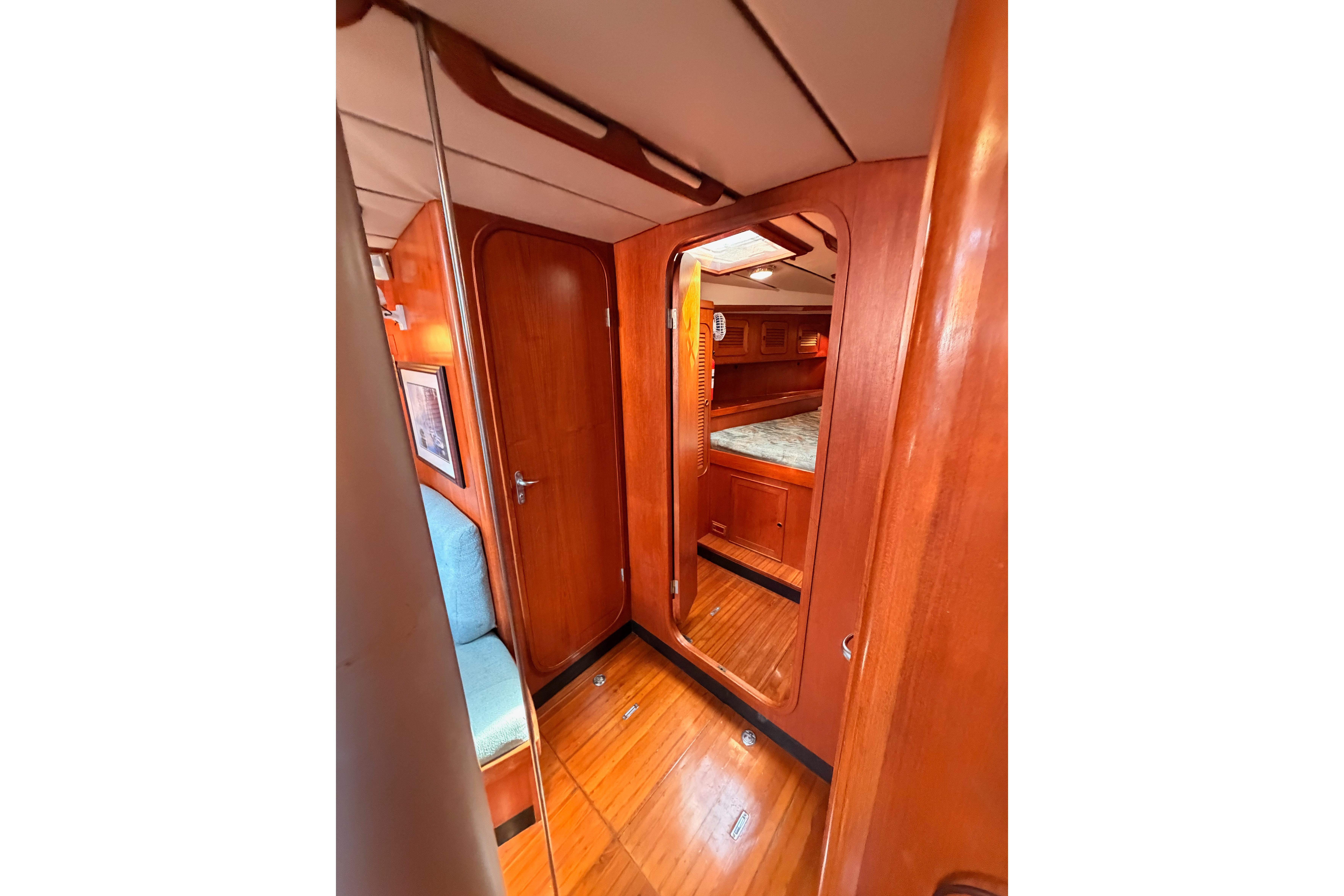 Interior of 1991 Hylas 51 yacht, featuring polished wood and cozy cabin space.