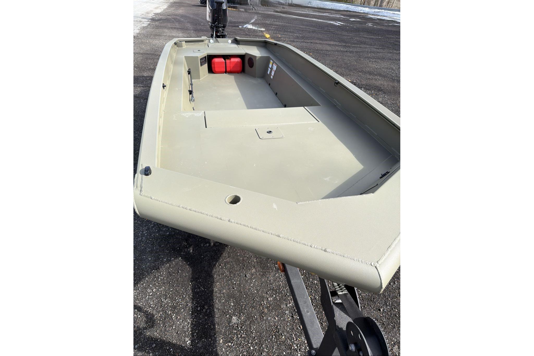 2026 Tracker Grizzly 1650 T Prairie Wings Edition boat on trailer, viewed from the bow.
